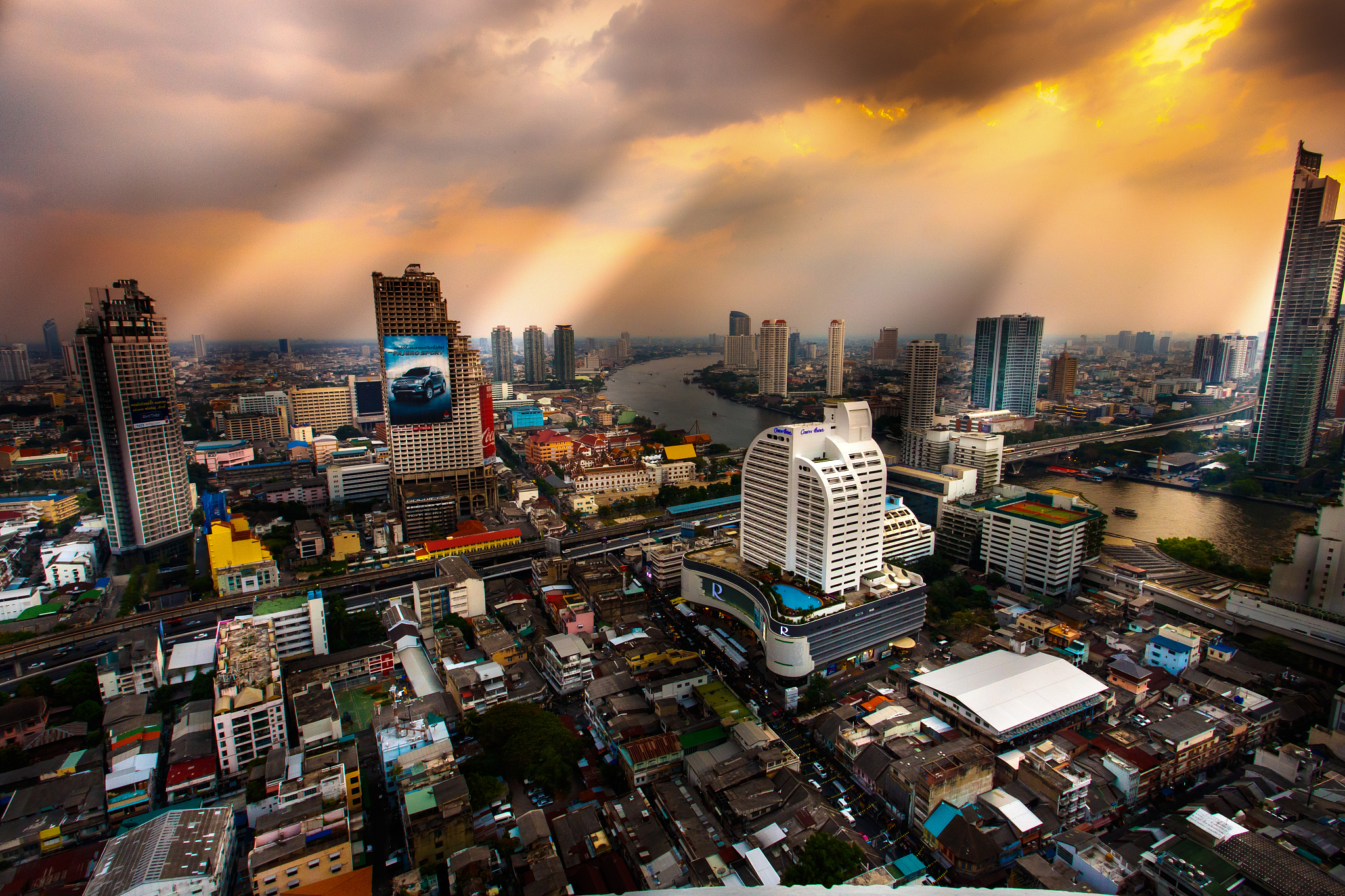 high angle view of modern buildings against sky during sunset