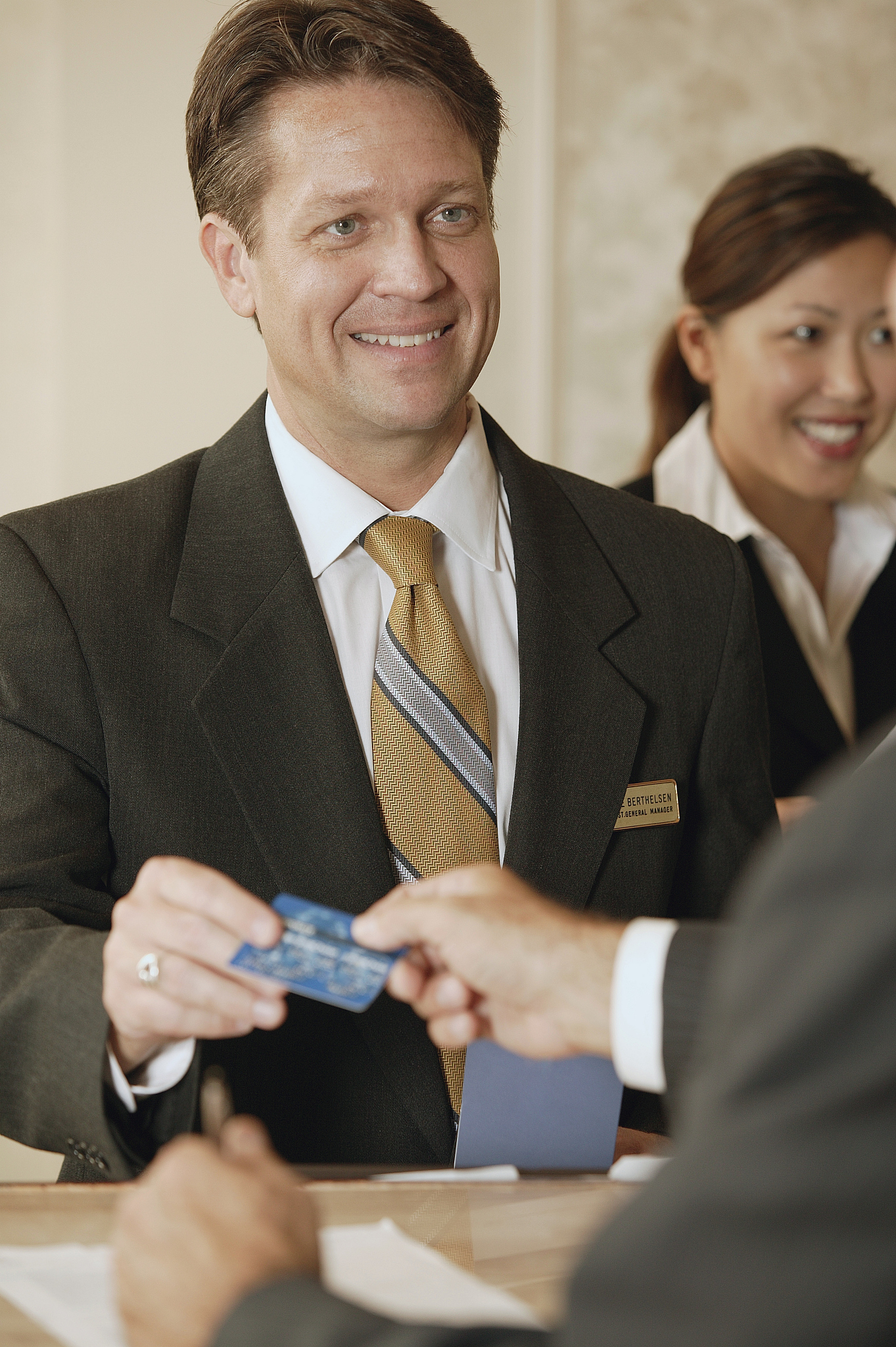 concierge taking credit card at hotel front desk