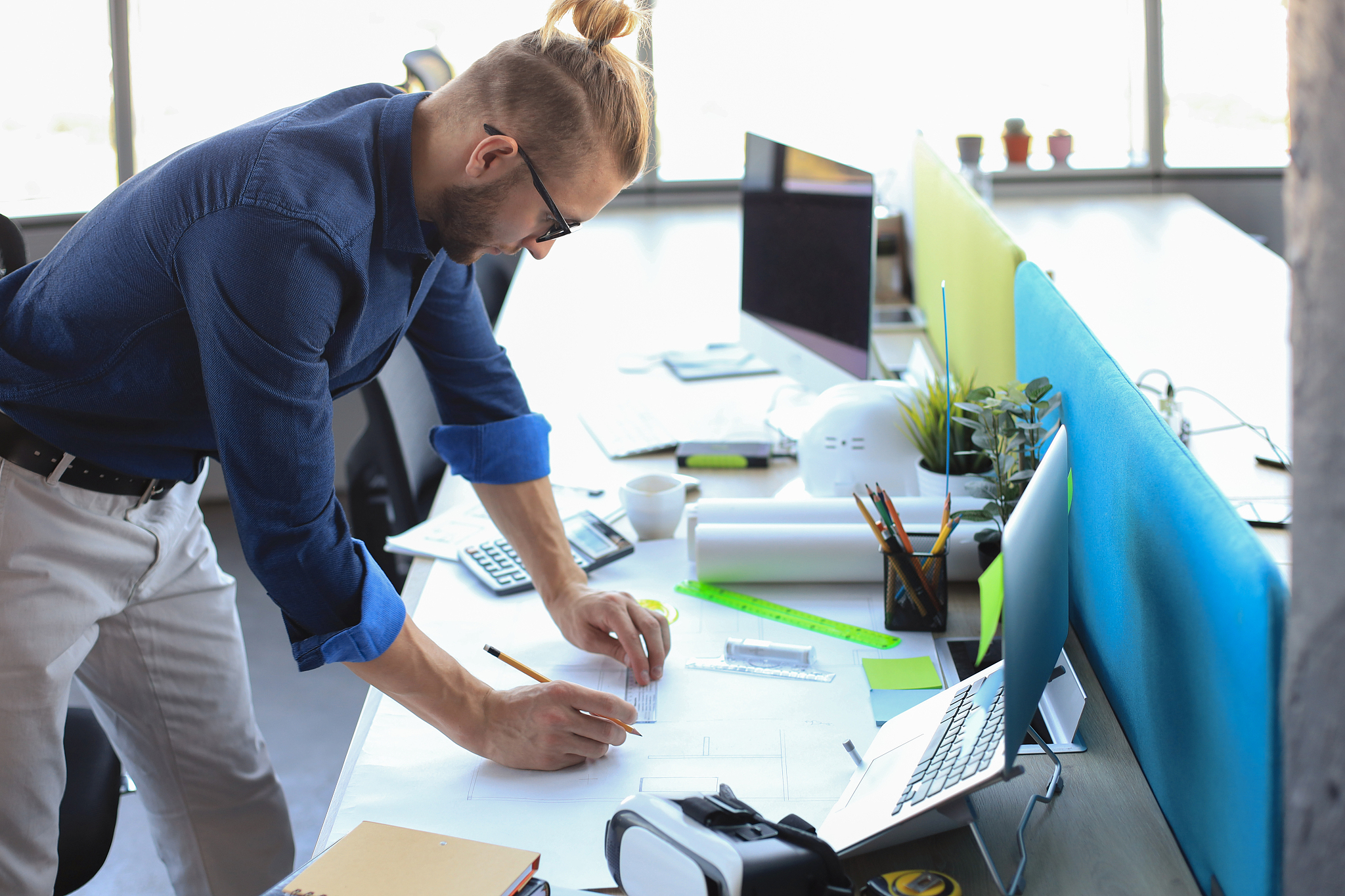 shot of a handsome male architect working on a design in his off