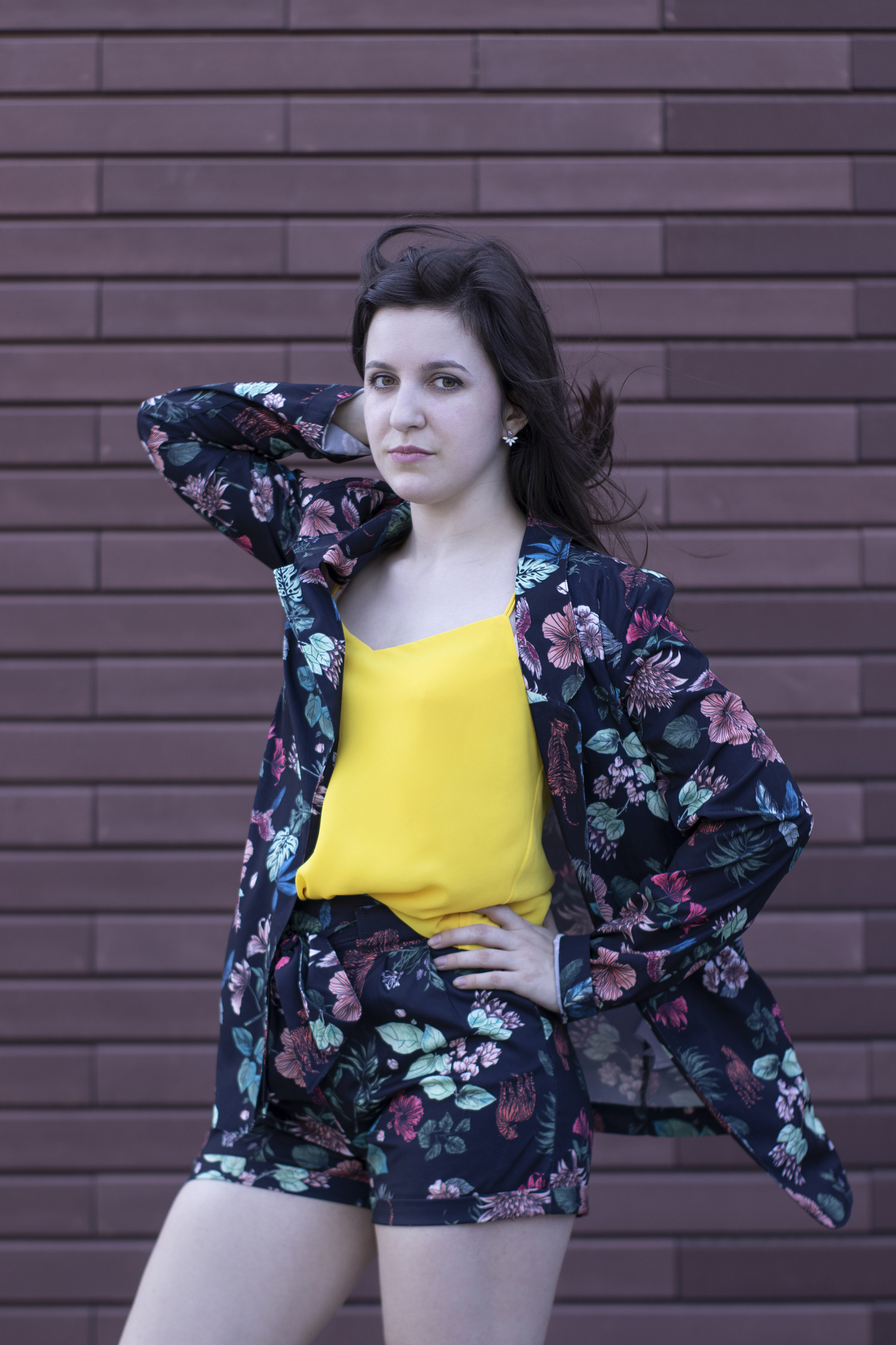 attractive young brunette woman in yellow t-shirt and flowery sh