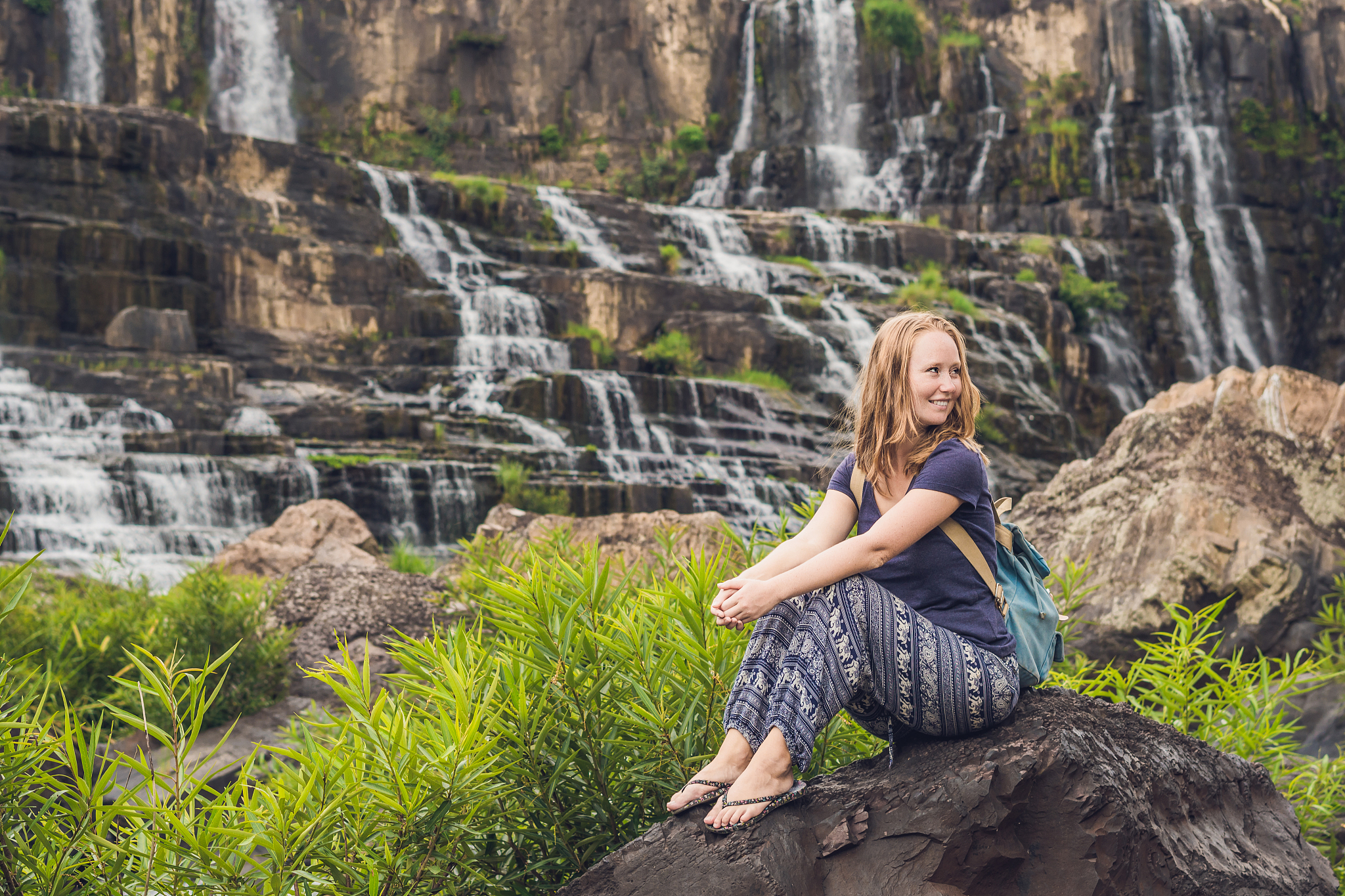 young woman hiker, tourist on the background of amazing pongour 