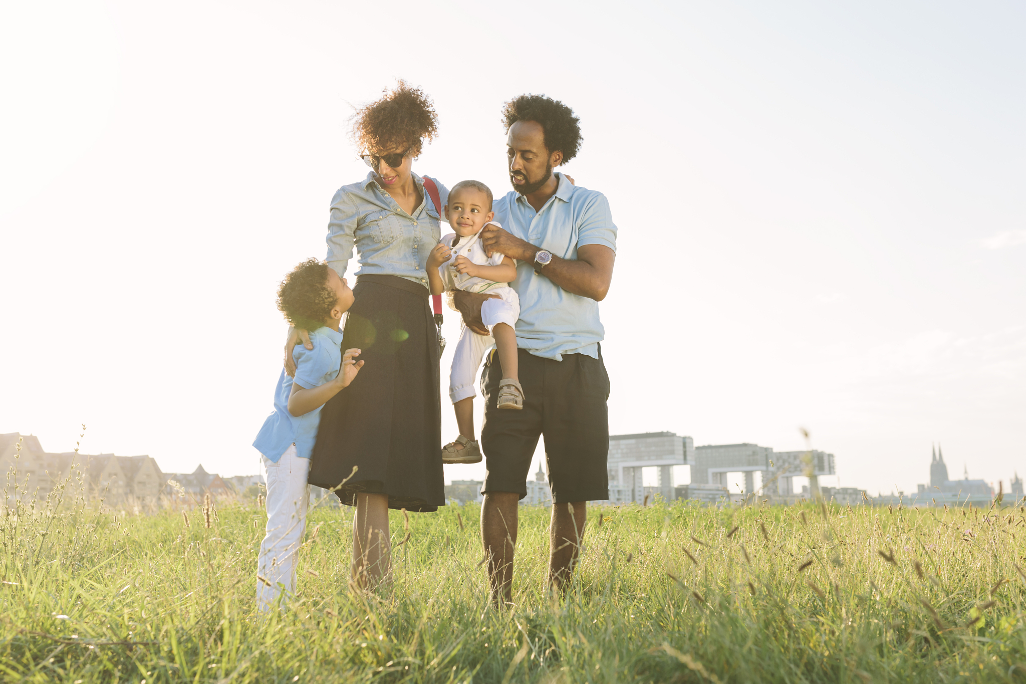 germany, cologne, family of four in a field