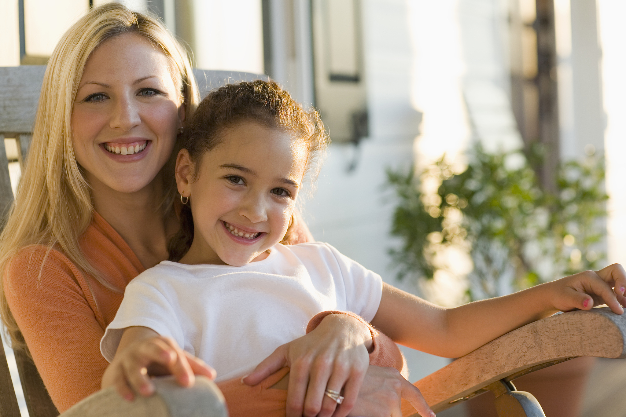 girl sitting on woman's lap