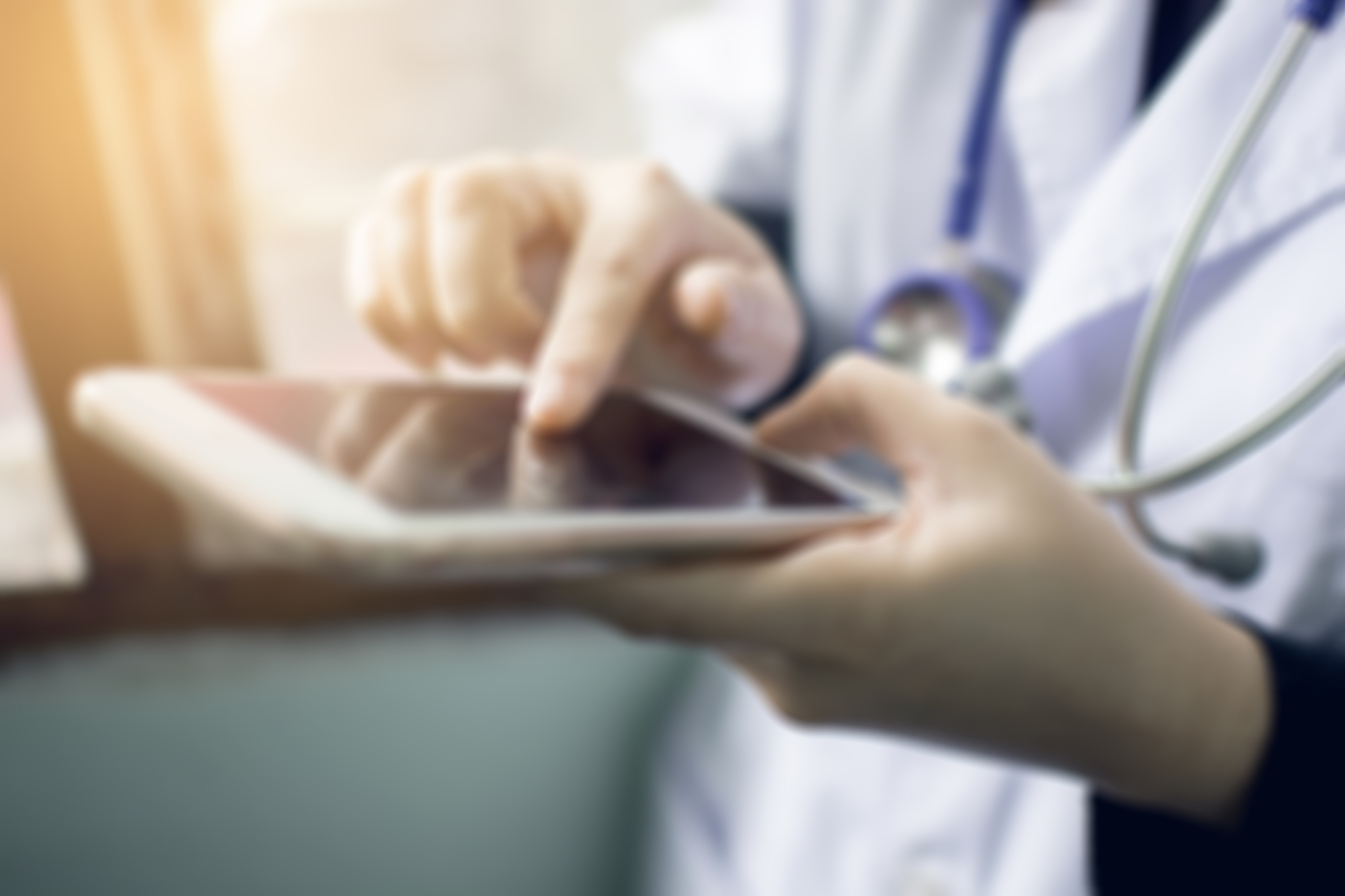 soft focus of woman doctor hand holding and touching blank scree