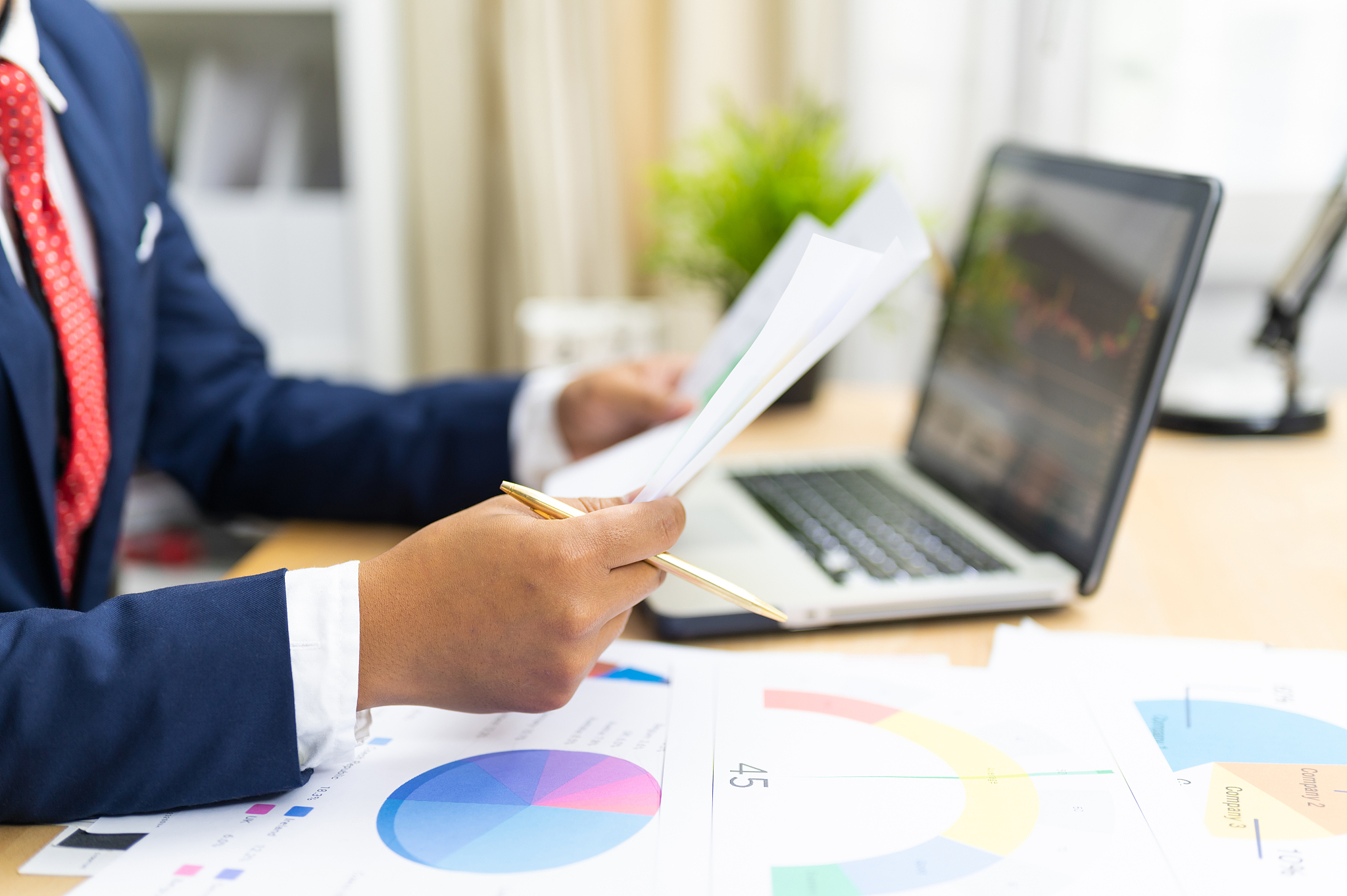 business owner analyzing sale report and marketing cost for next