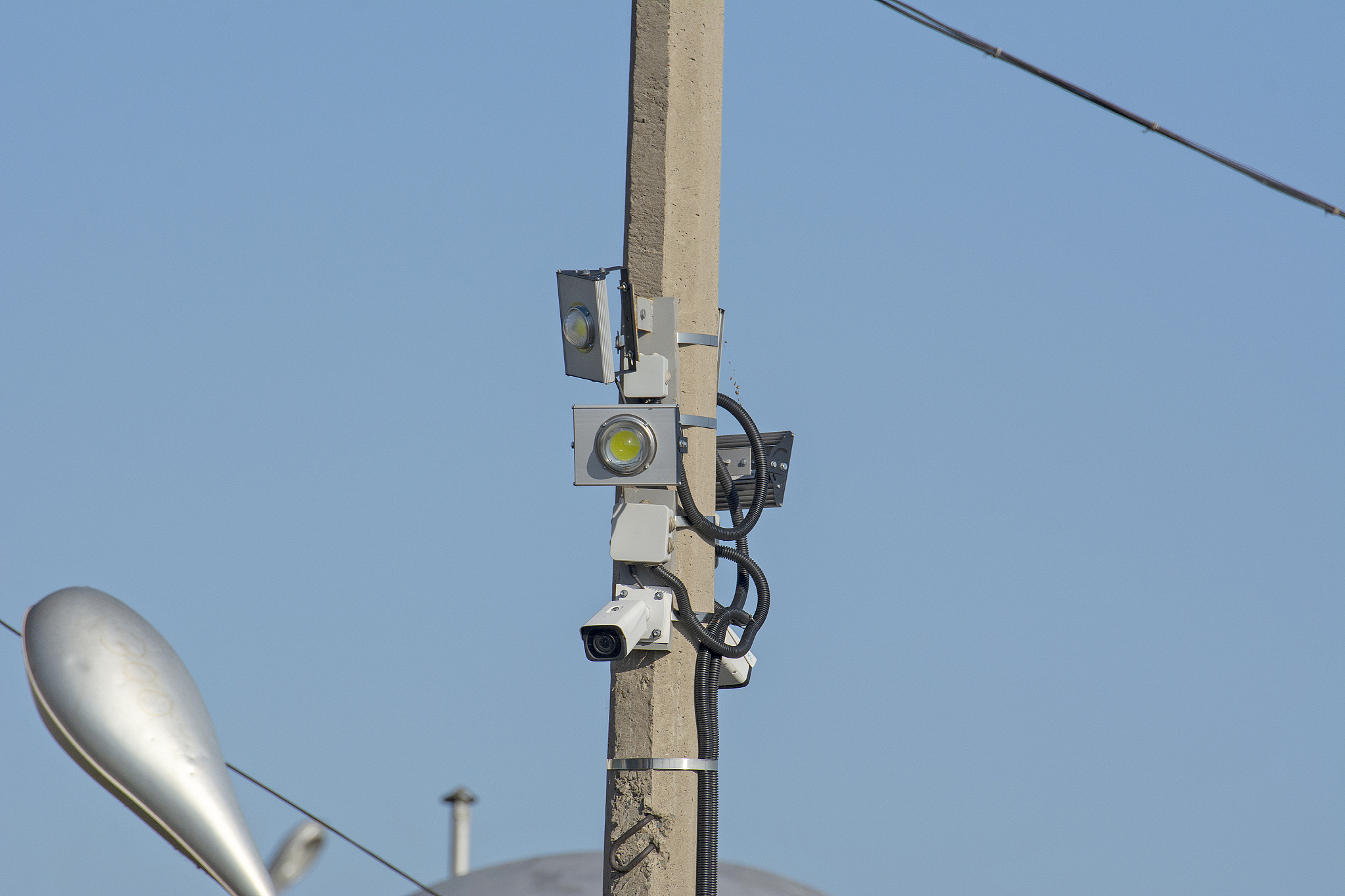 street surveillance camera mounted on a pole with led spotlights