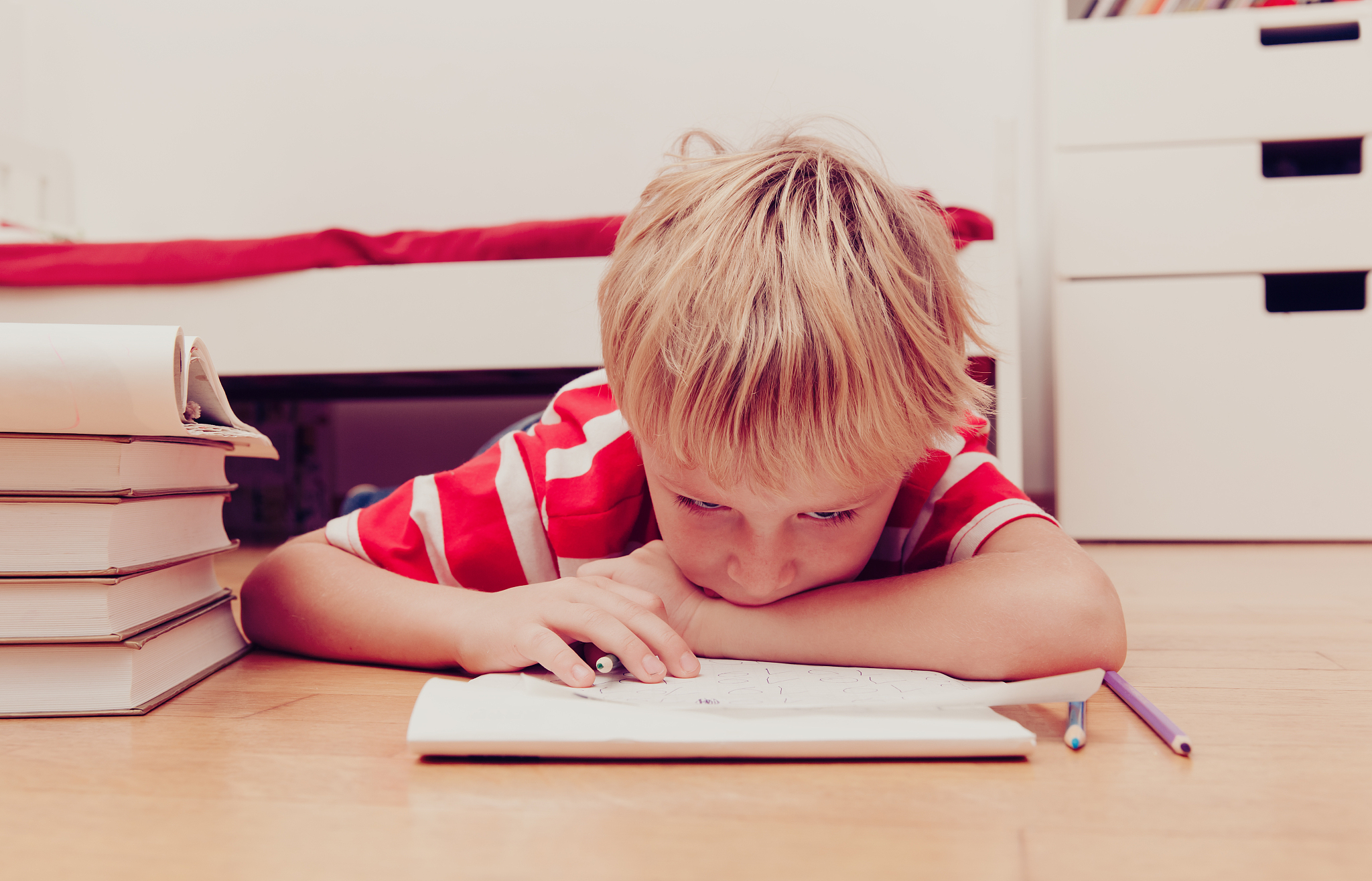 little boy hates doing homework