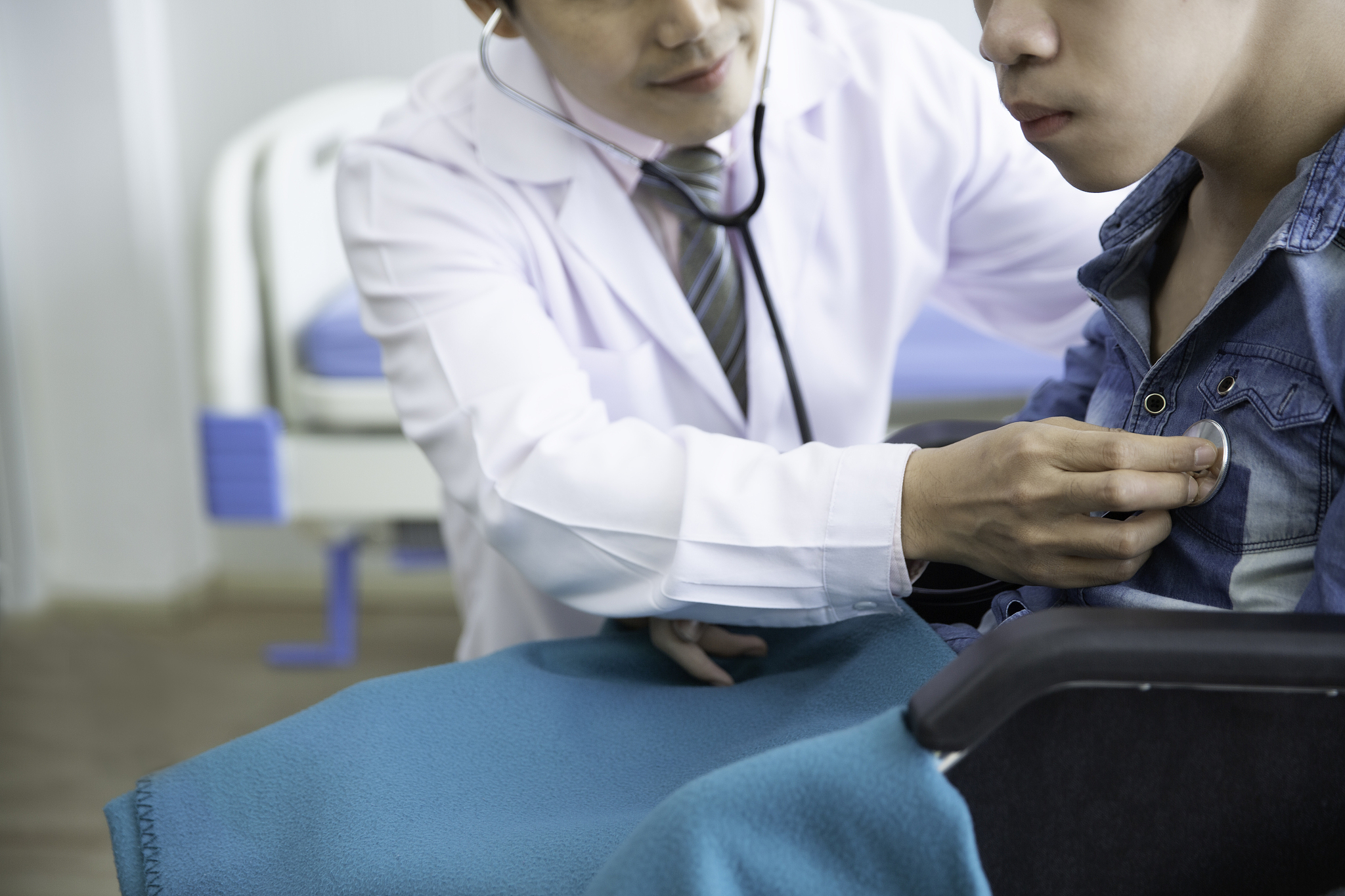 asian doctor use stethoscope checkup  disability wheel chair pat