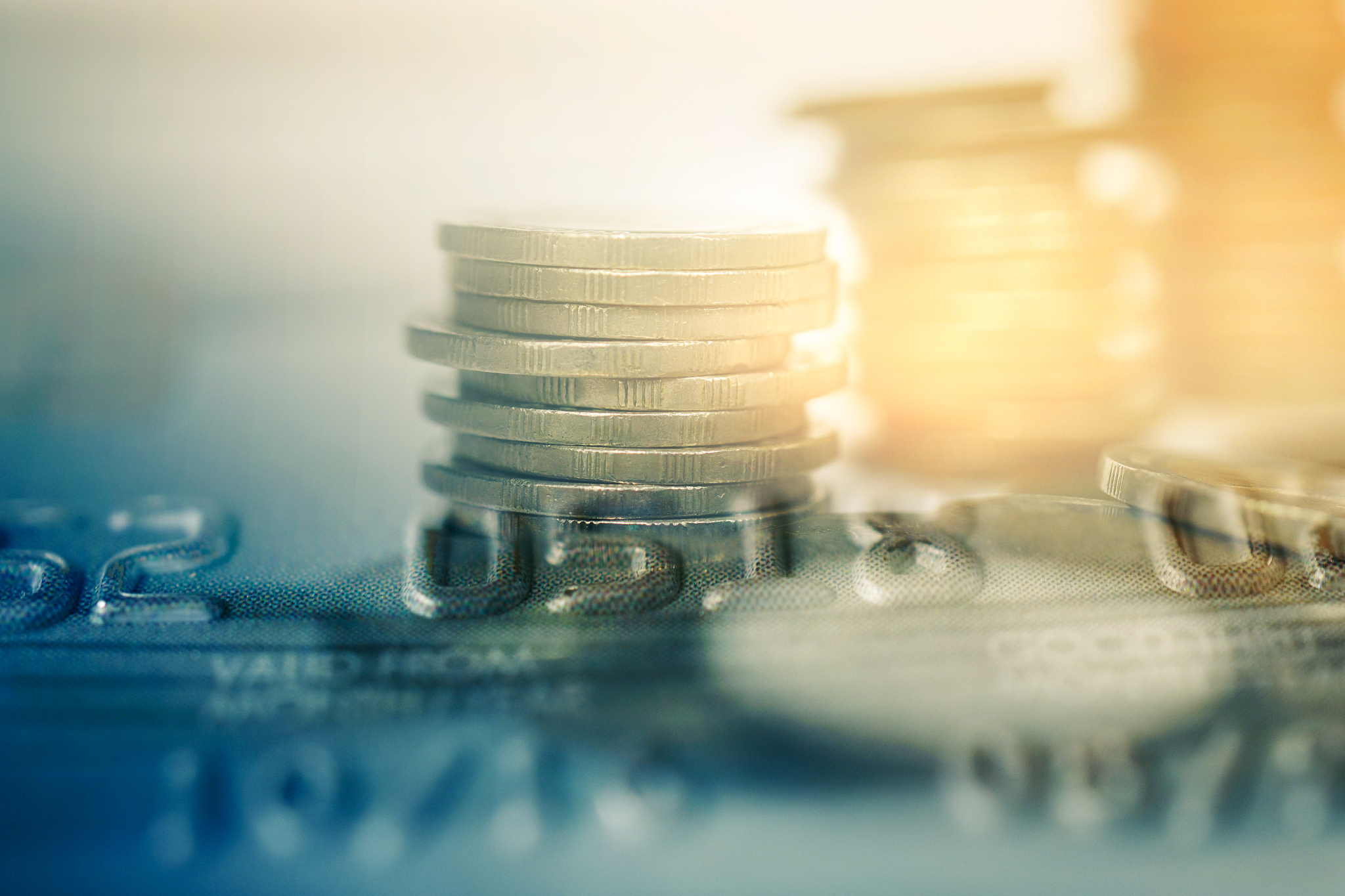 double exposure of row of coins  and credit card  for business a