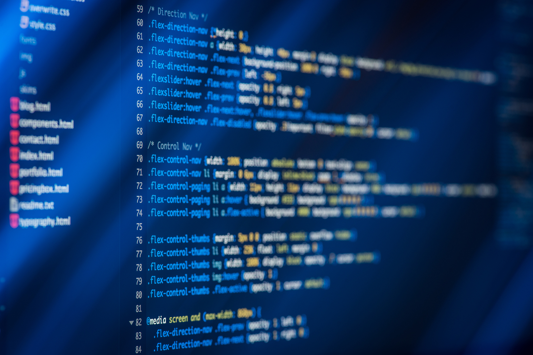 html and css code developing screenshot with light effects.