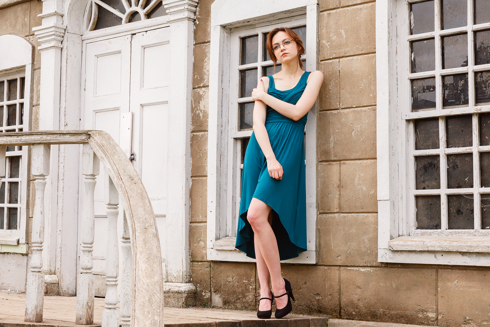 elegant young woman on stair of an old palace