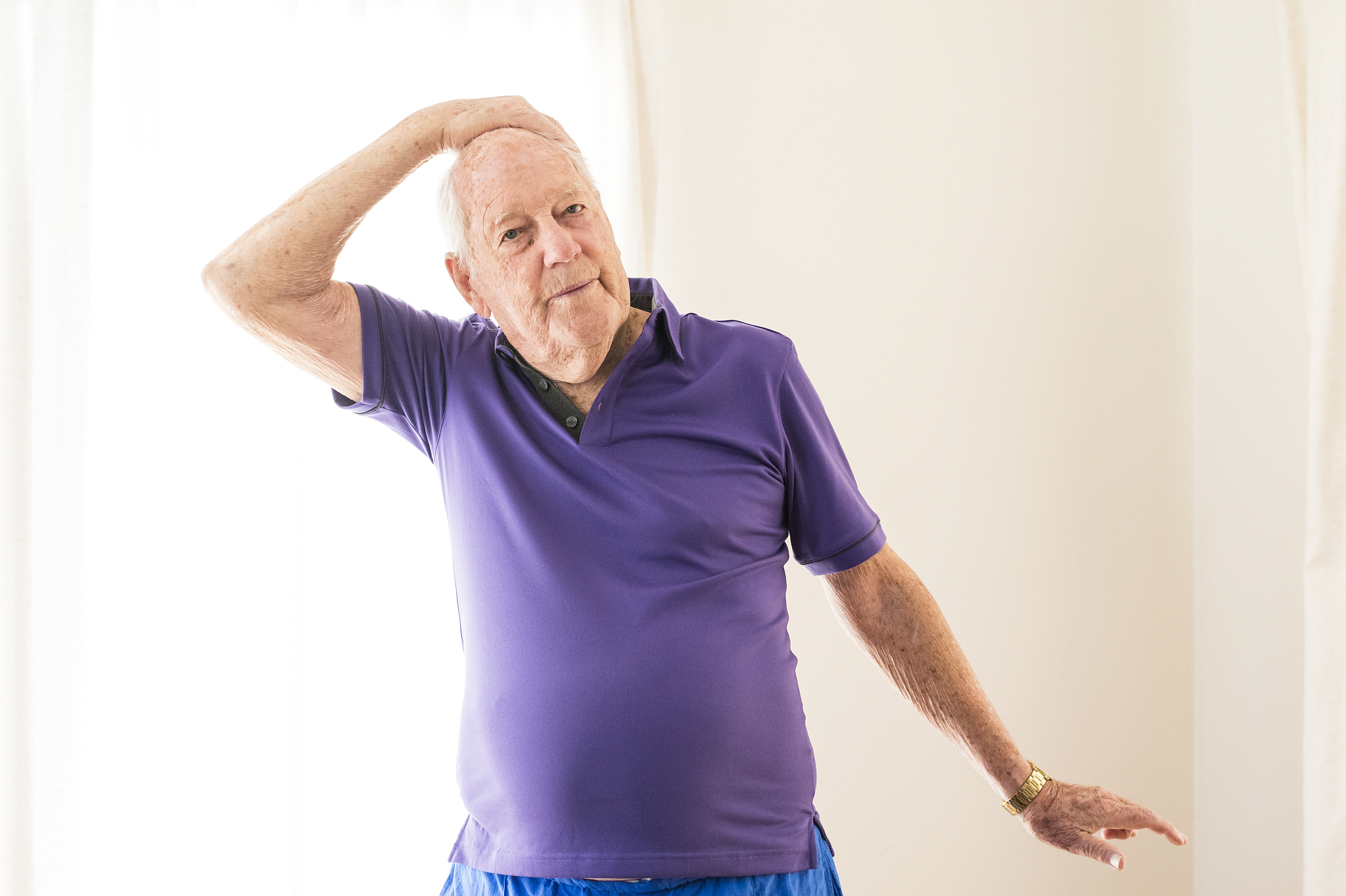 senior man stretching at yoga class