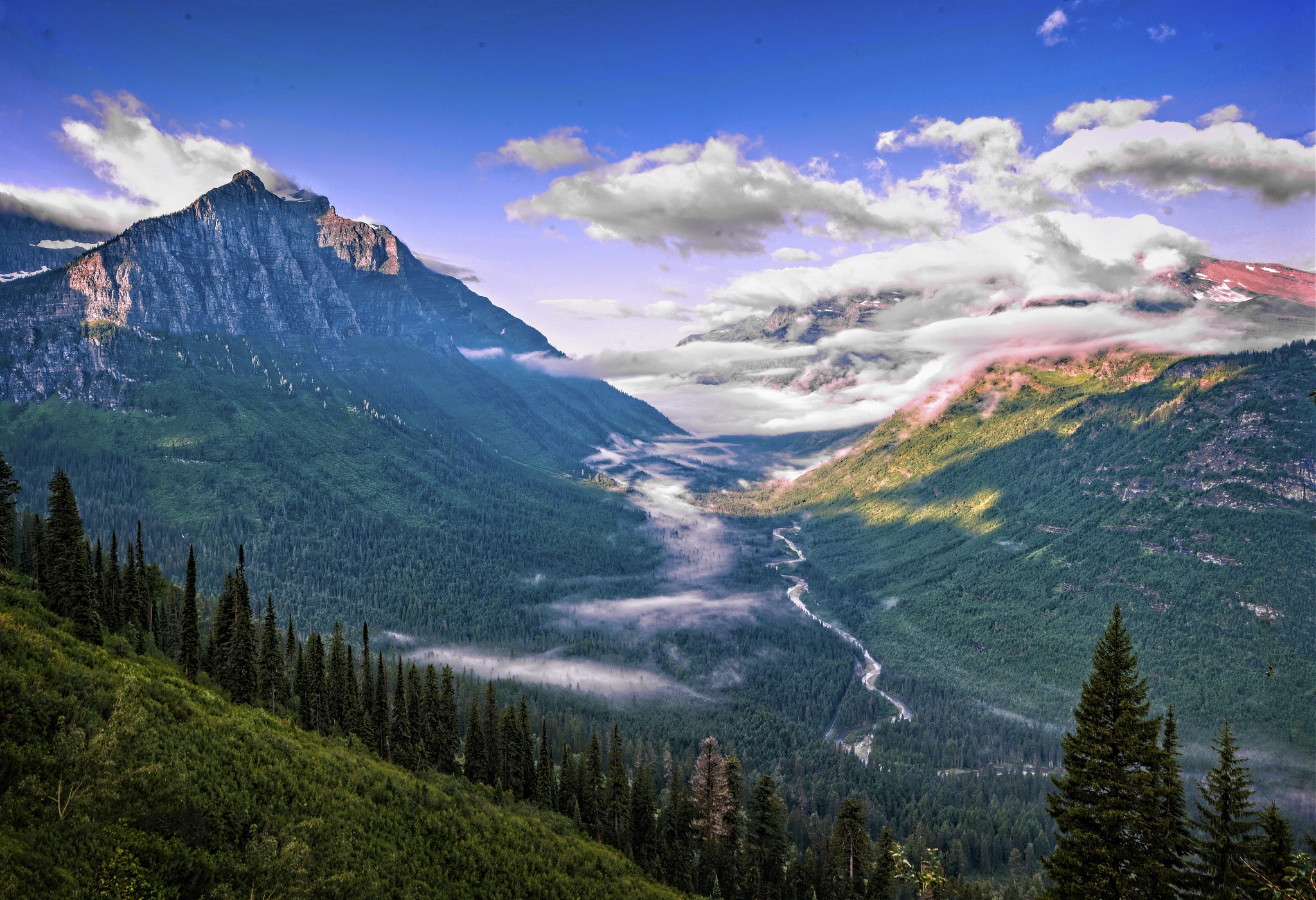 looking down into a cloud covered valley below.