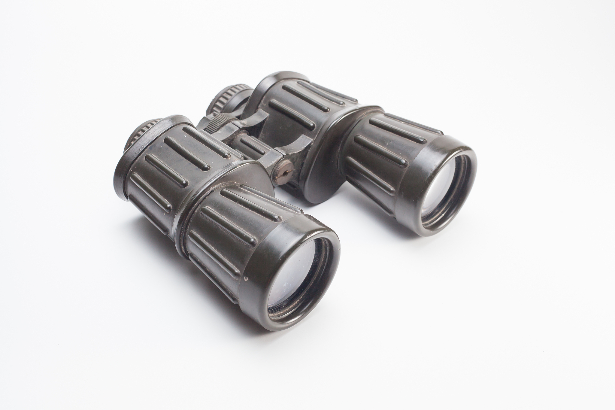 close-up of binoculars over white background