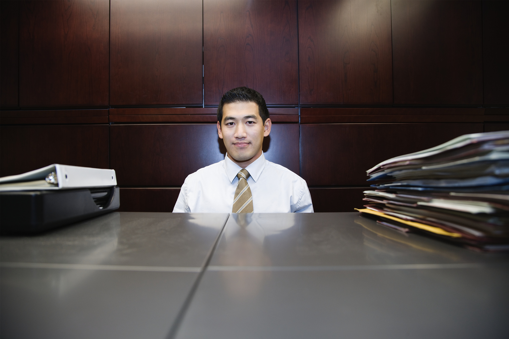 businessman at file cabinets with folders, portrait