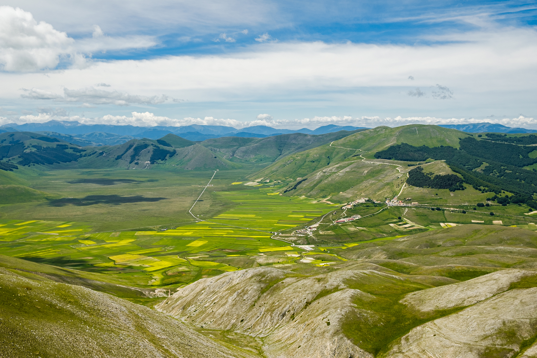 scenic view of landscape against sky in castelluccio, umbria