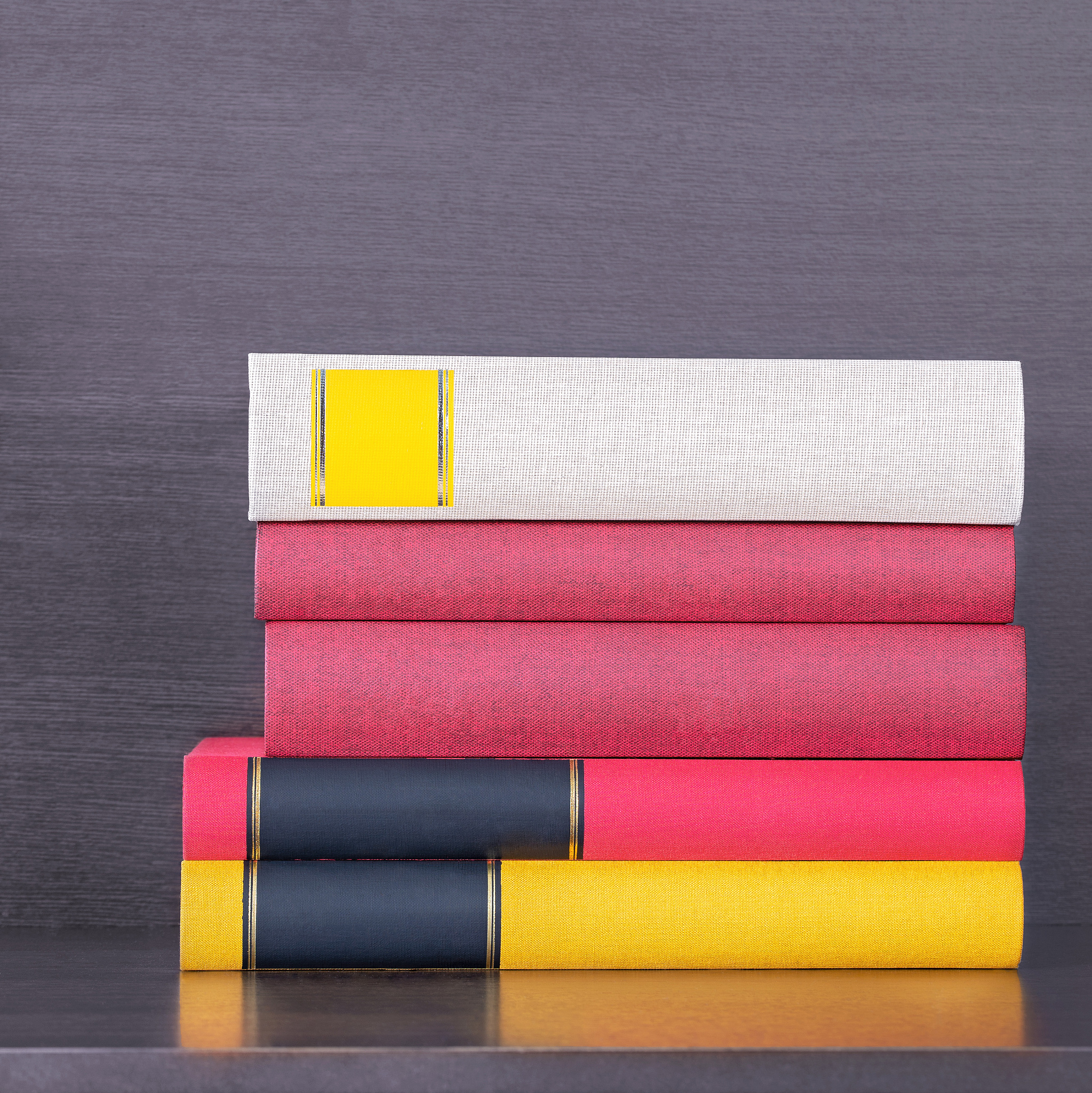 stack of new colorful books in the wooden bookself.