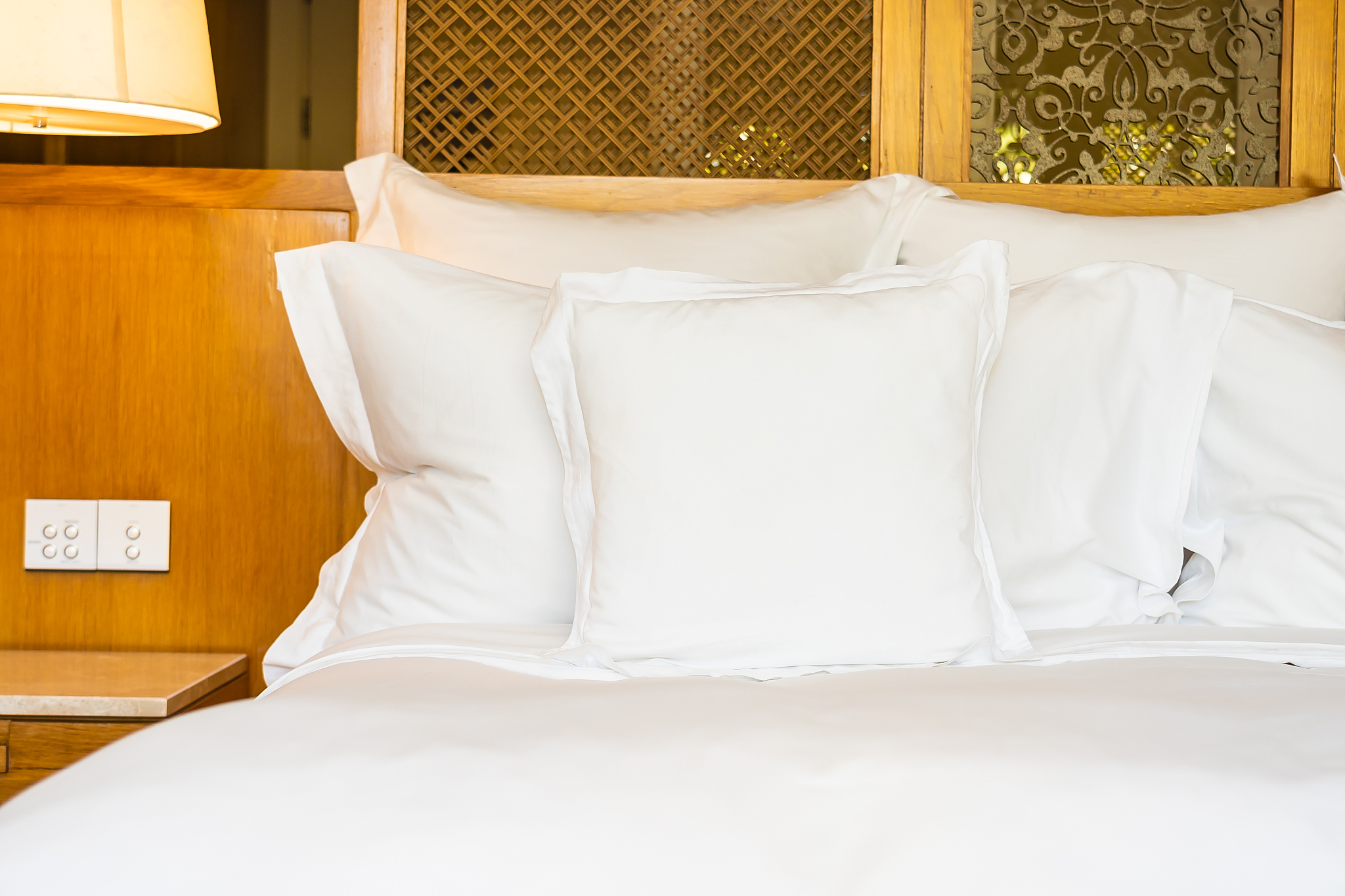comfortable white pillow on bed decoration in bedroom