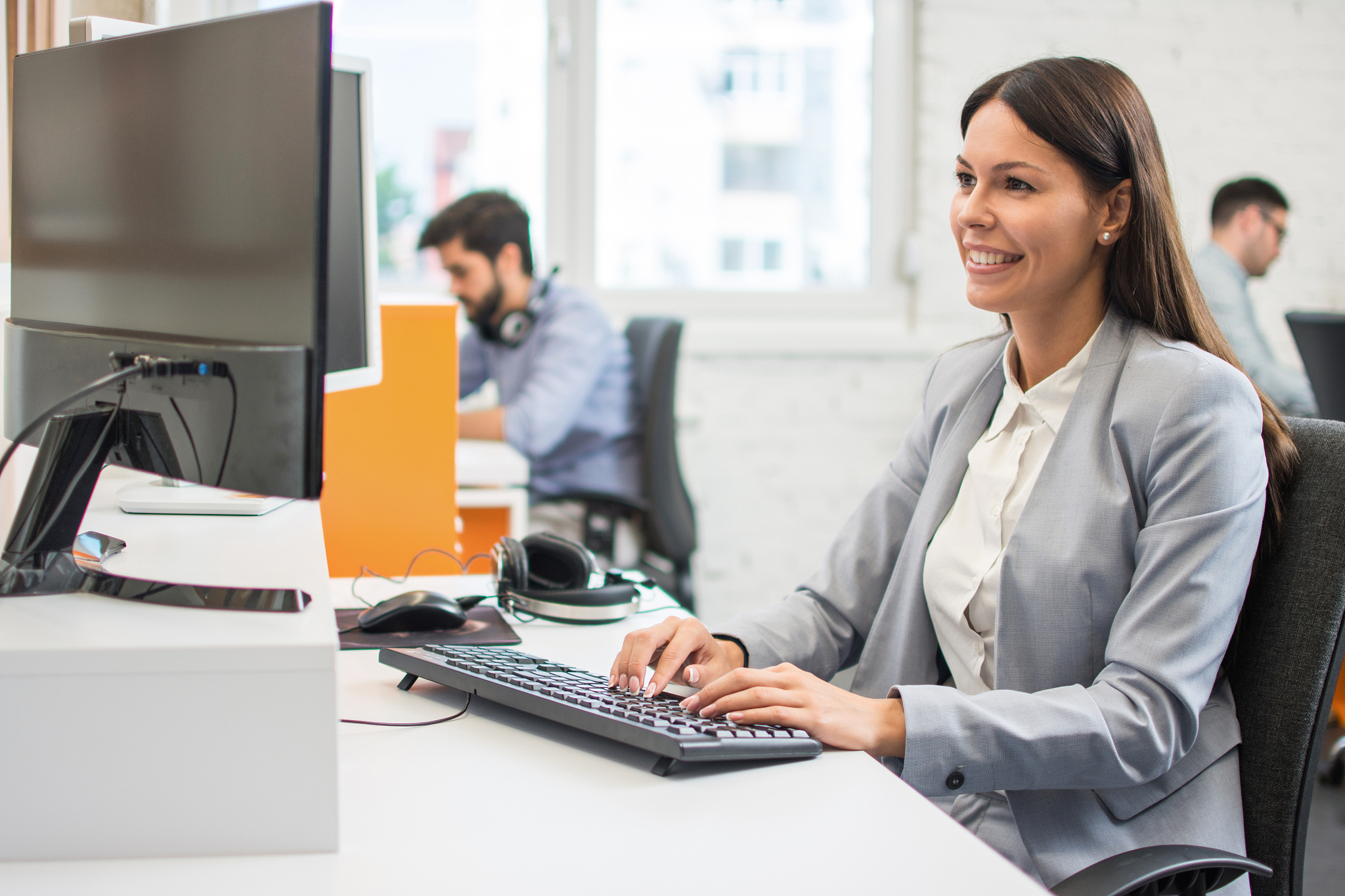 smiling businesswoman using computer in office
