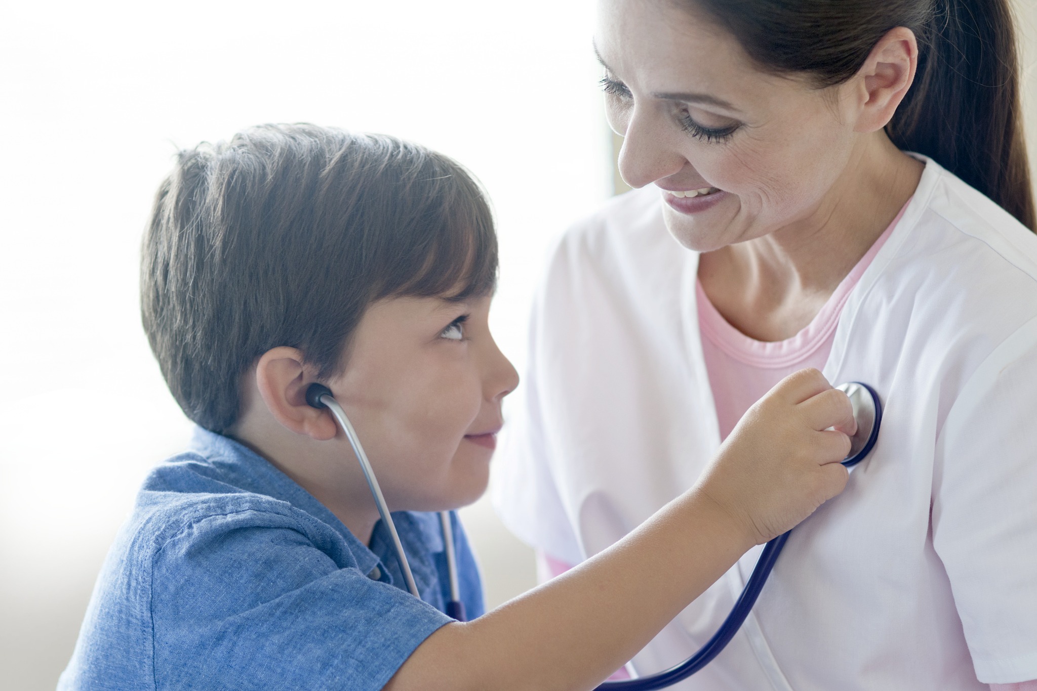 boy and nurse playing with stethoscope