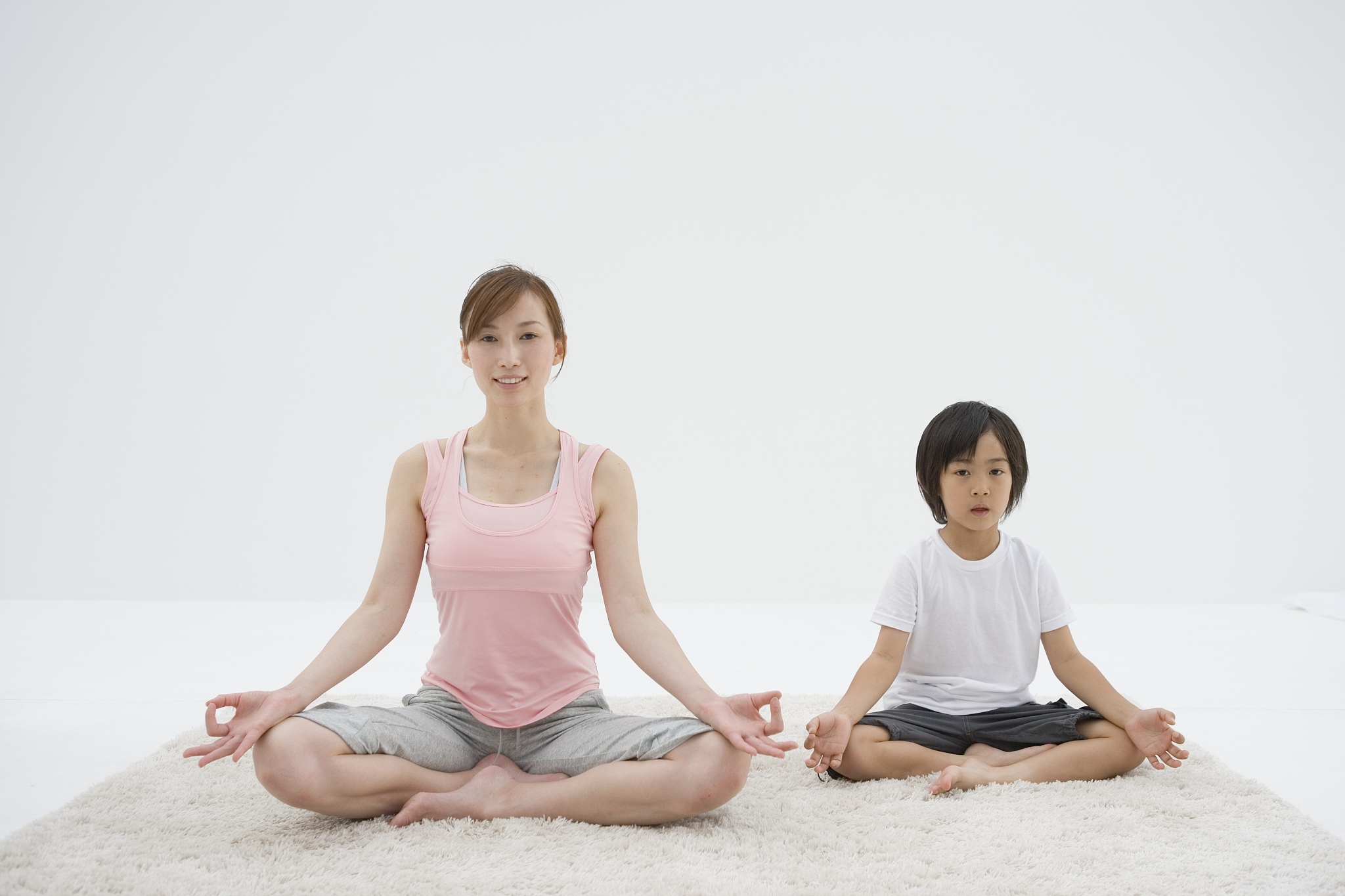 a mother and a son doing yoga