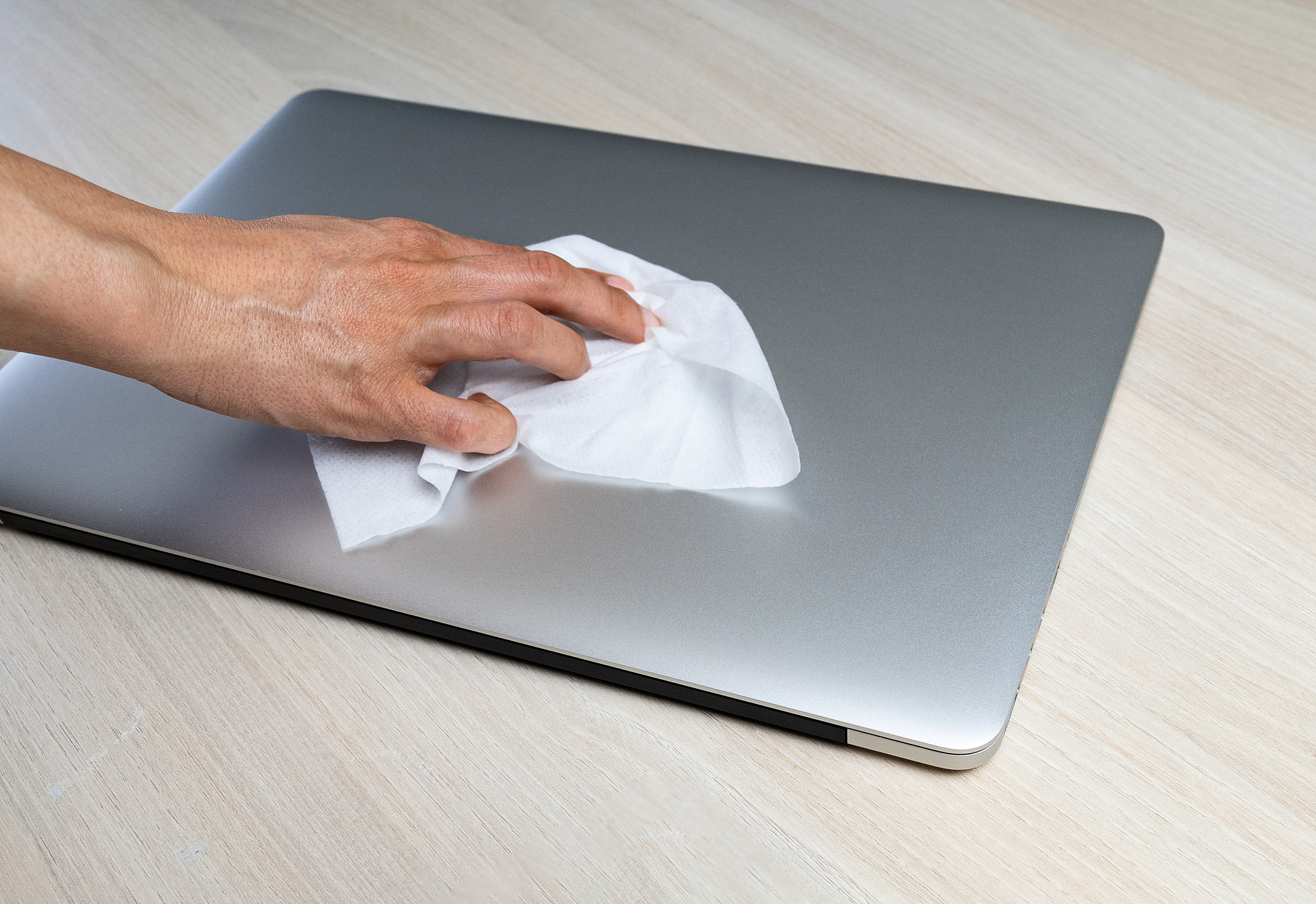 laptop being wiped by a person to remove virus and to be protect
