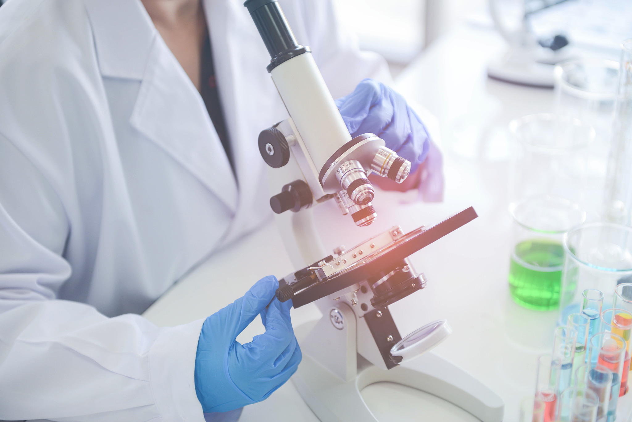 medical research scientist using the microscope in chemical lap