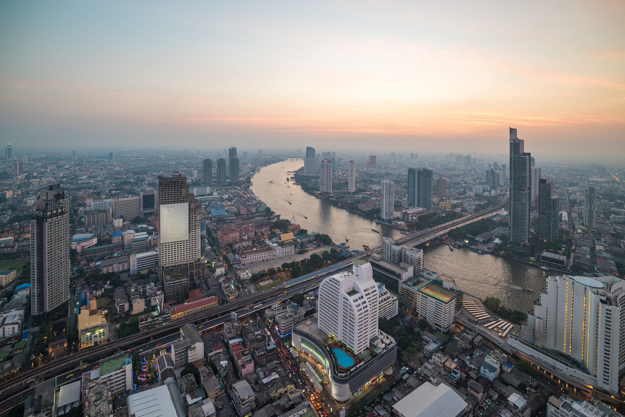 high angle view of city buildings during sunset