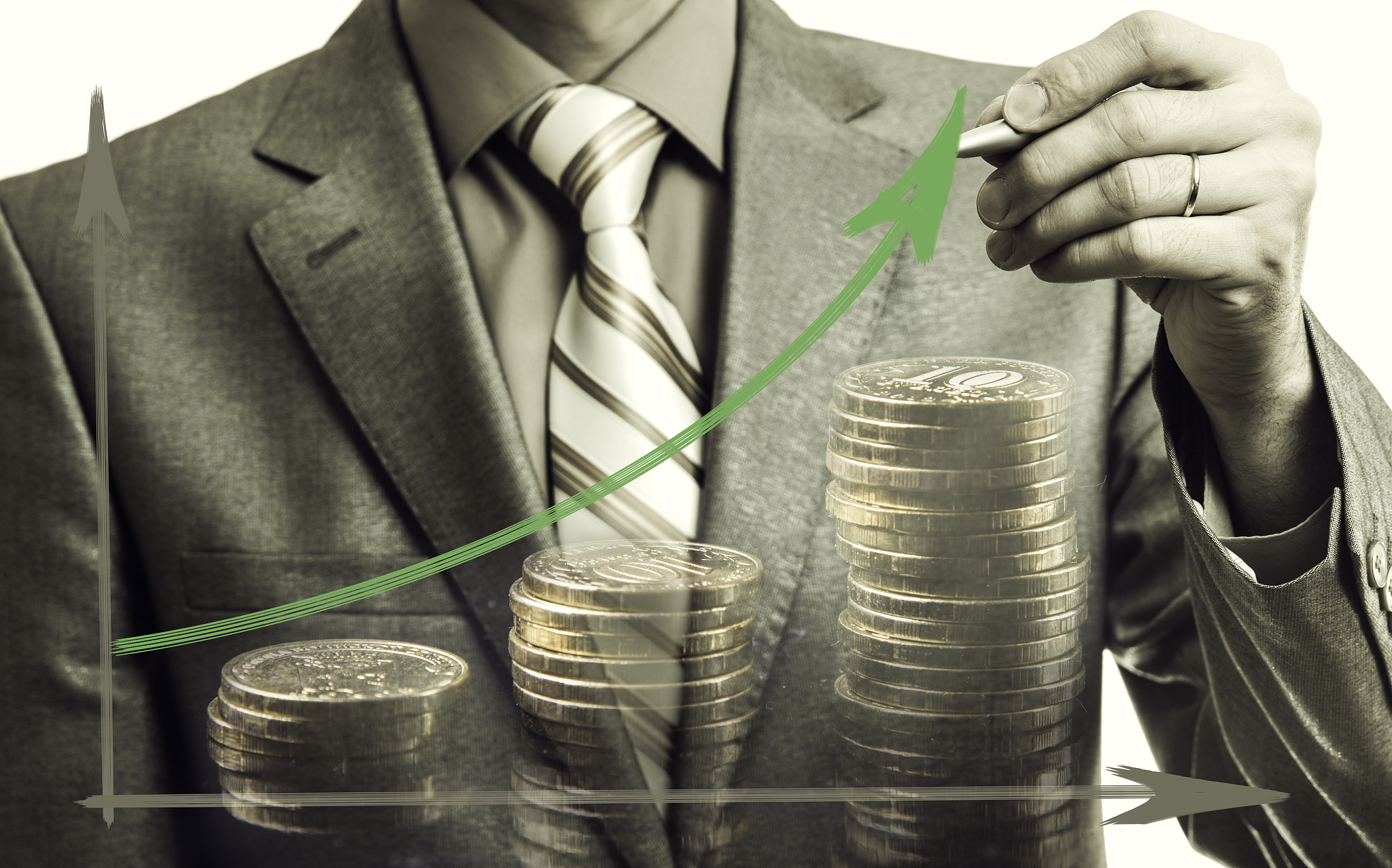 businessman drawing rising graph with coins, development and gro