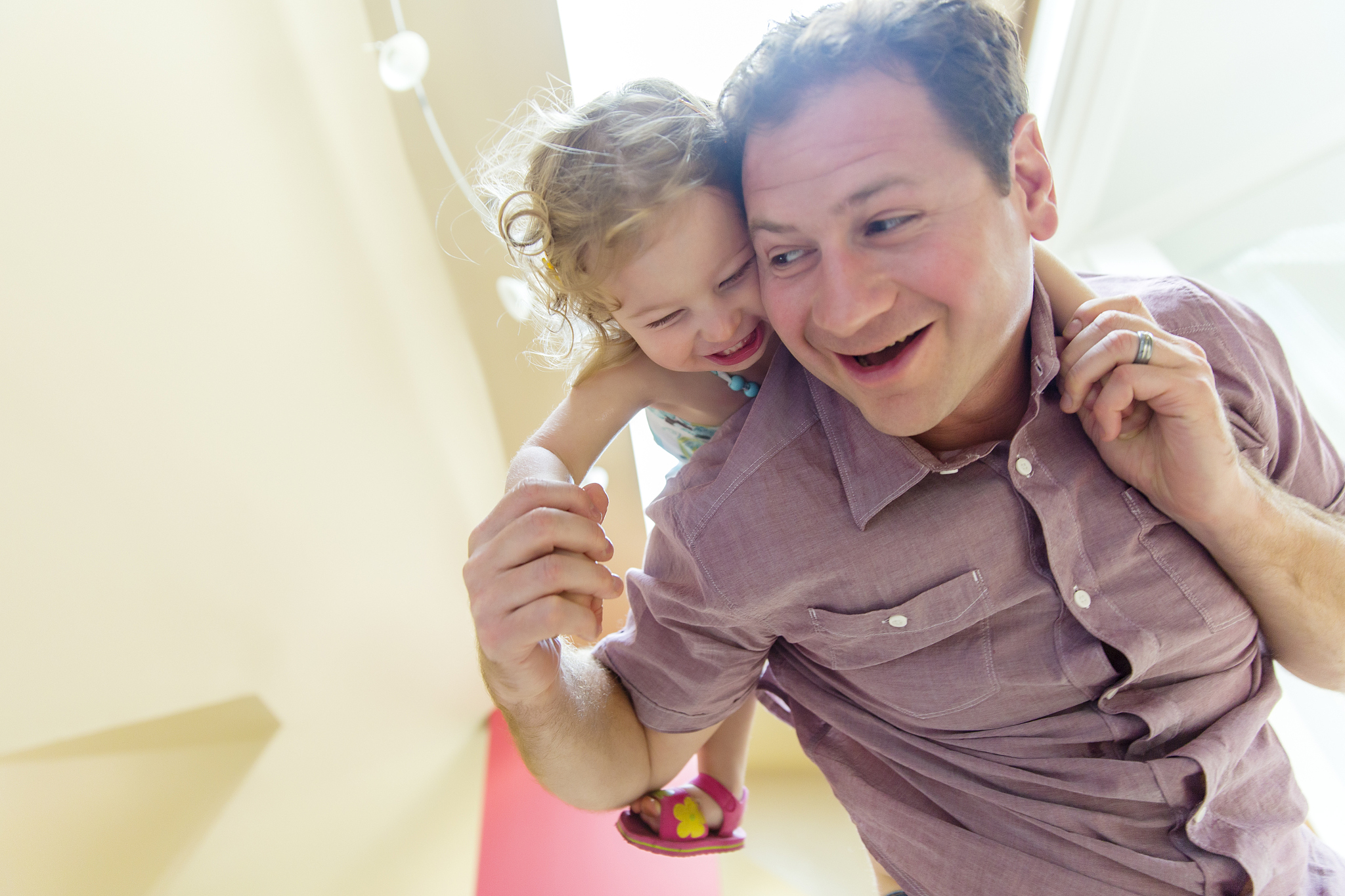 father carrying daughter piggyback