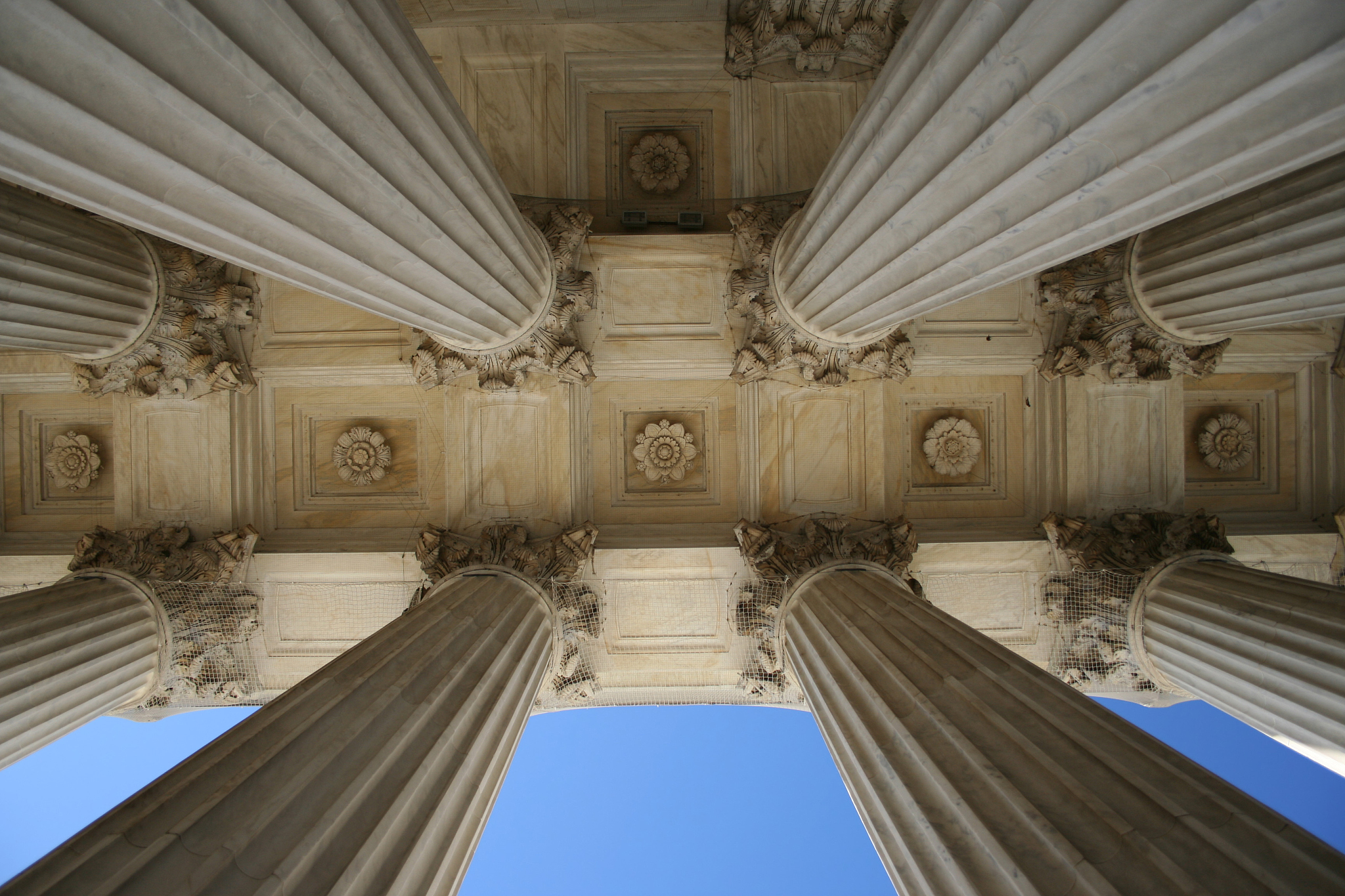 shot of marble columns at the supreme court, from below