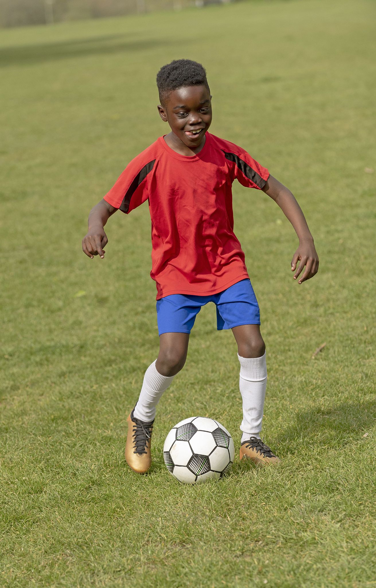 hampshire, england, uk, a nine year old footballer dribbles the 