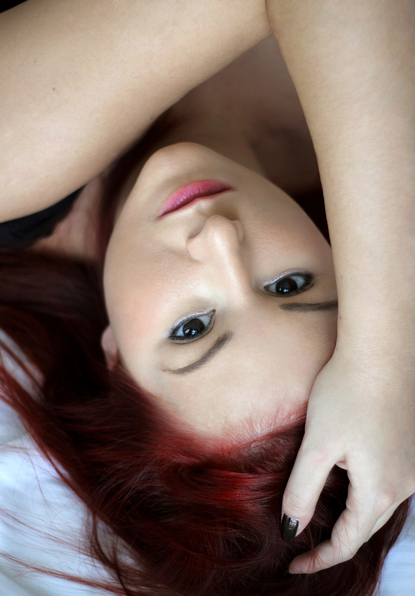 redhead young woman portrait laying on the bed