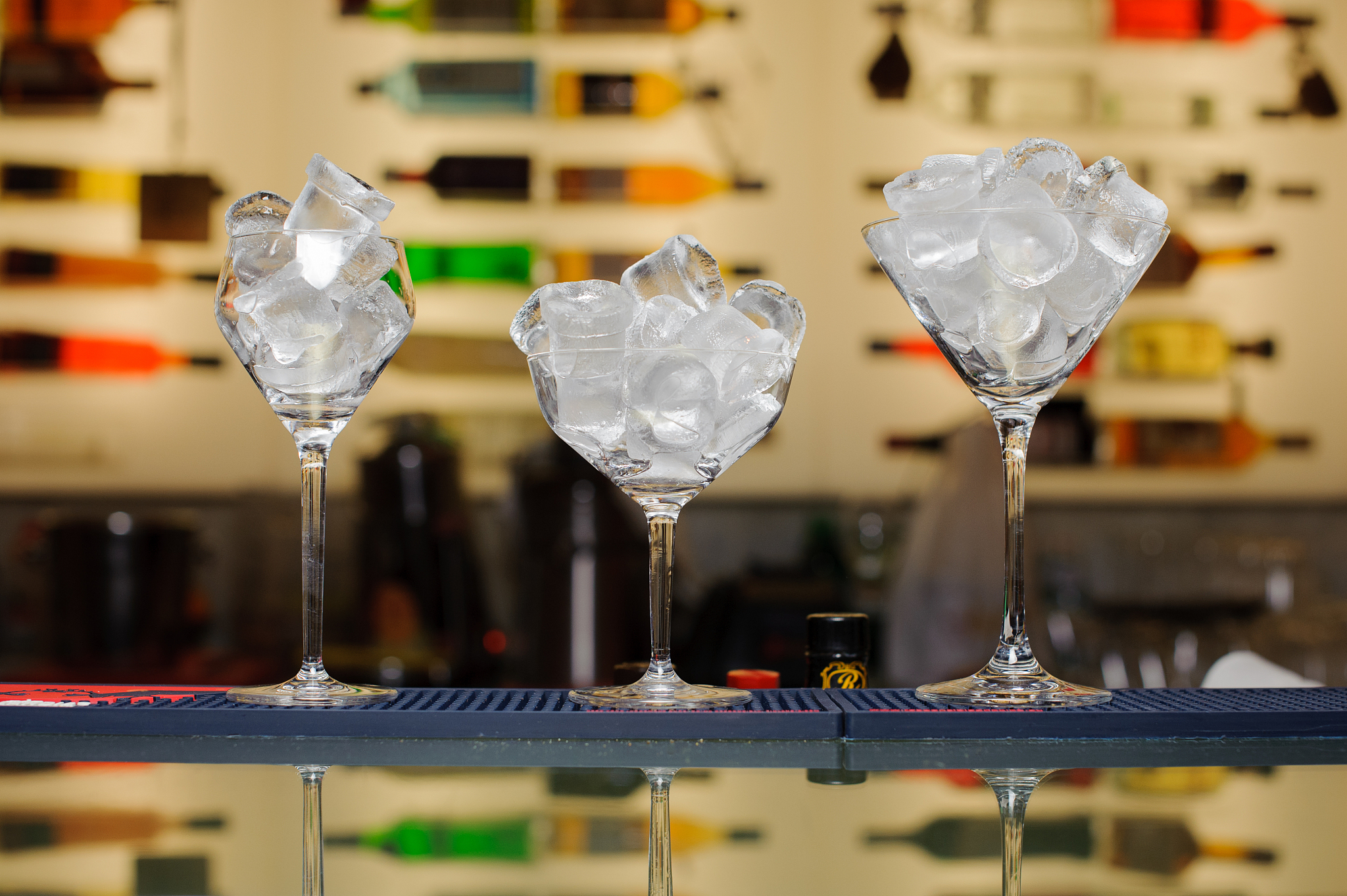three glasses with ice on the bar