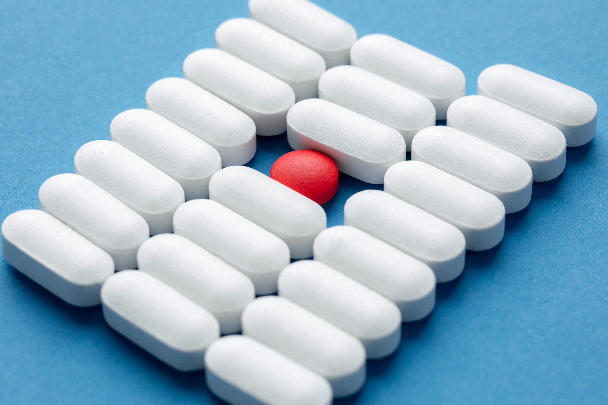 one red pill among white pills. concept of uniqueness