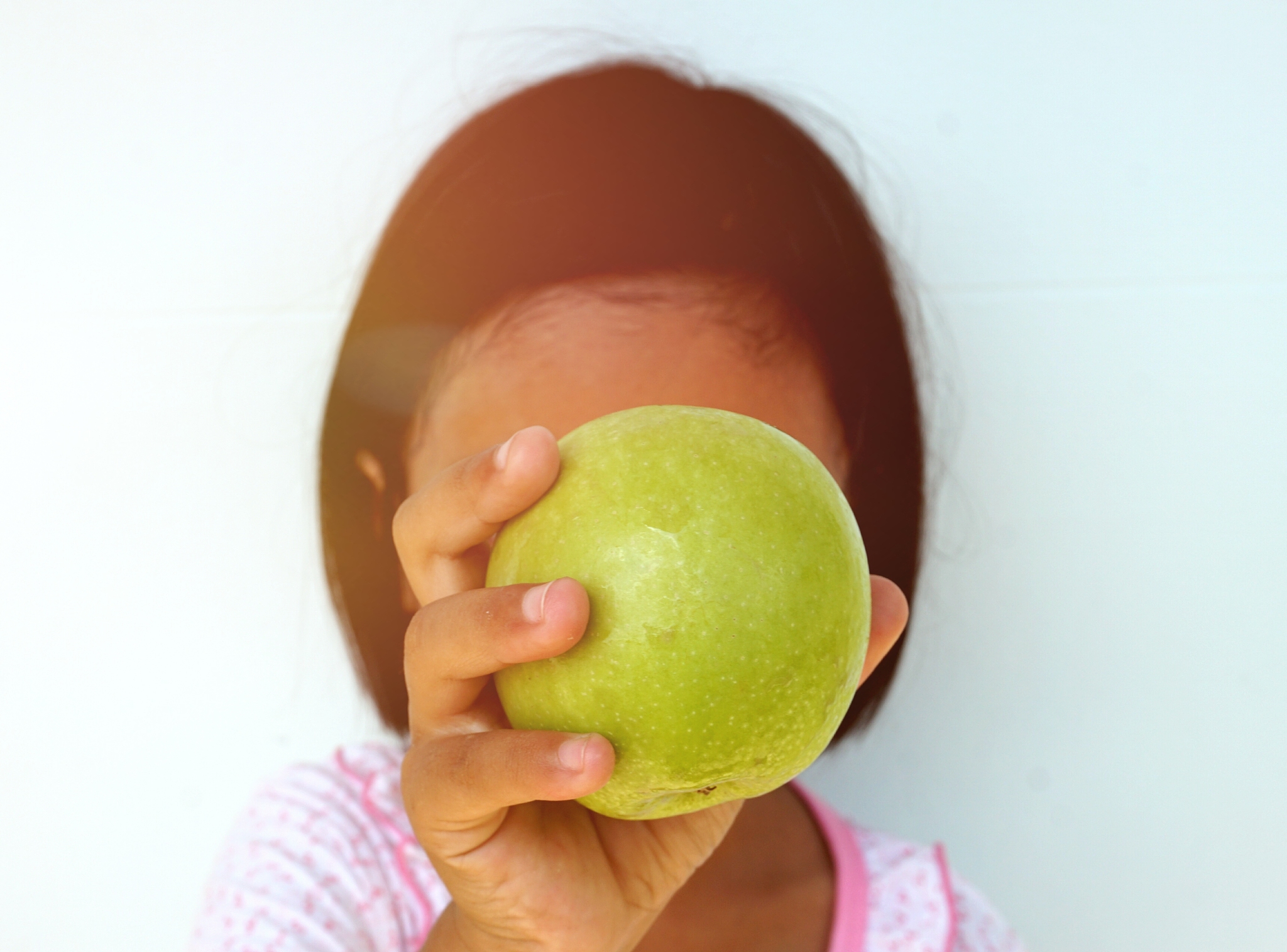 close-up of woman holding fruit