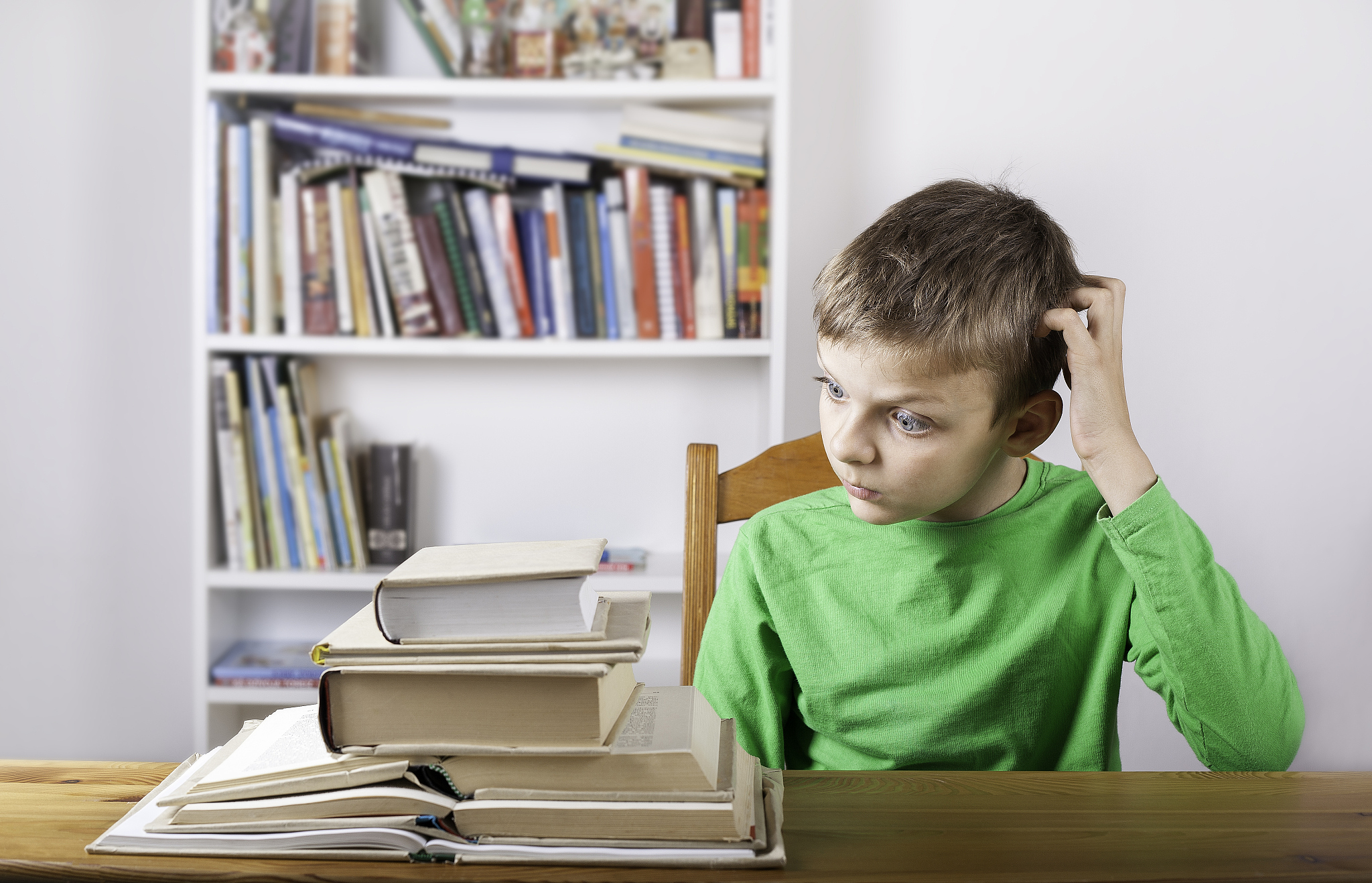 confused boy student reading book