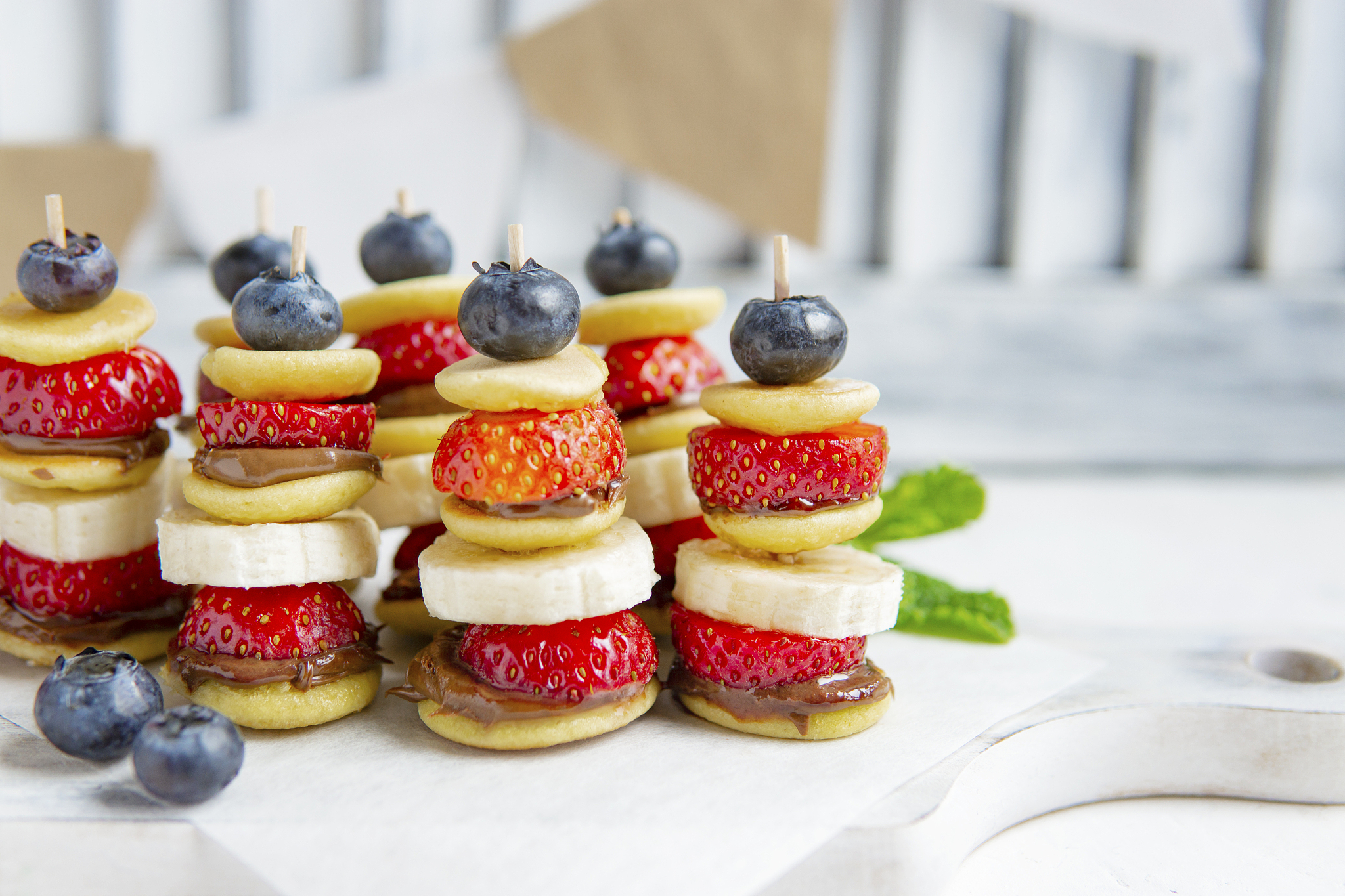 mini pancakes canape with berries, chocolate cream and banana, n