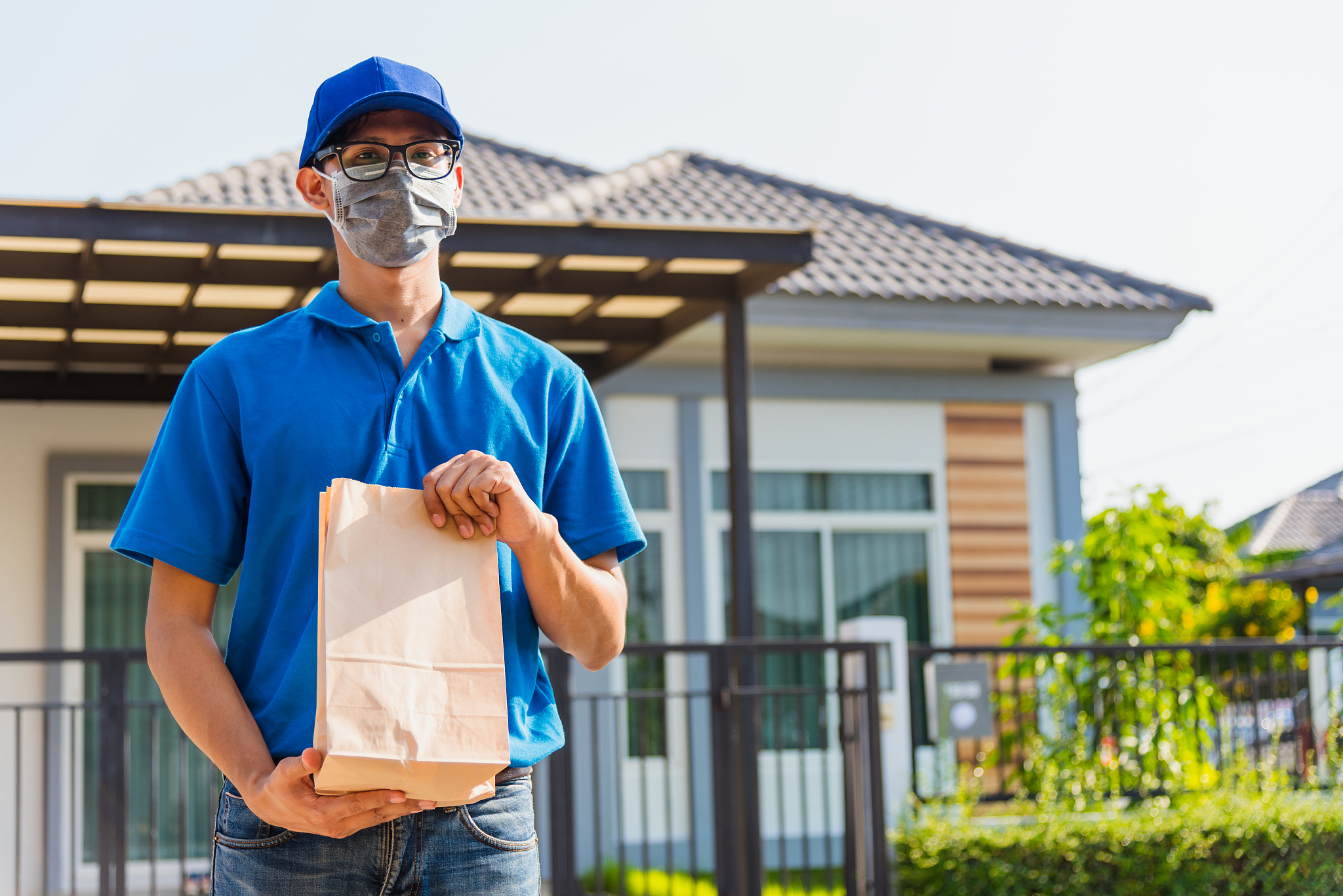 asian young delivery man courier online with food order takeaway