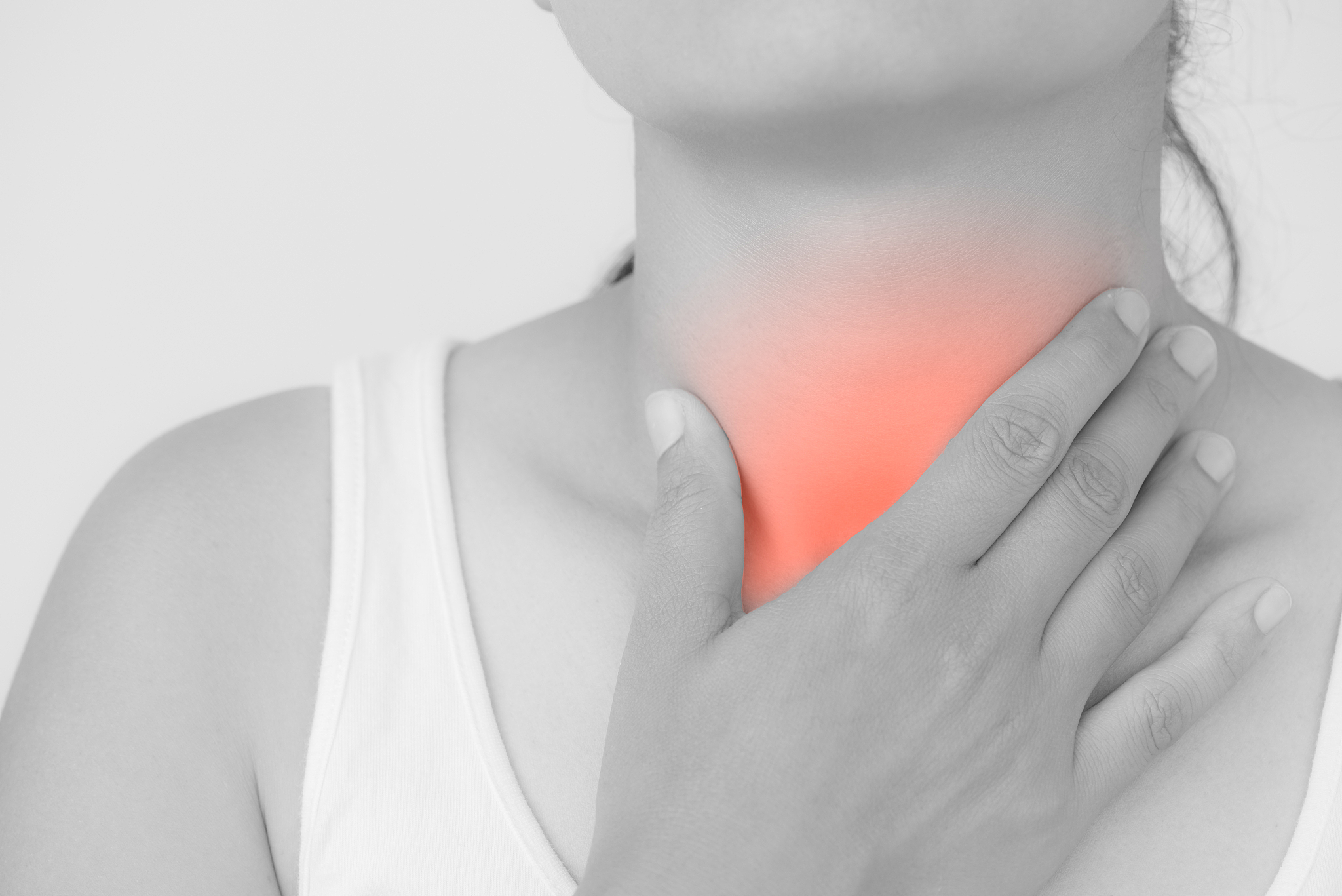 sore throat. closeup of beautiful young woman hand touching her 