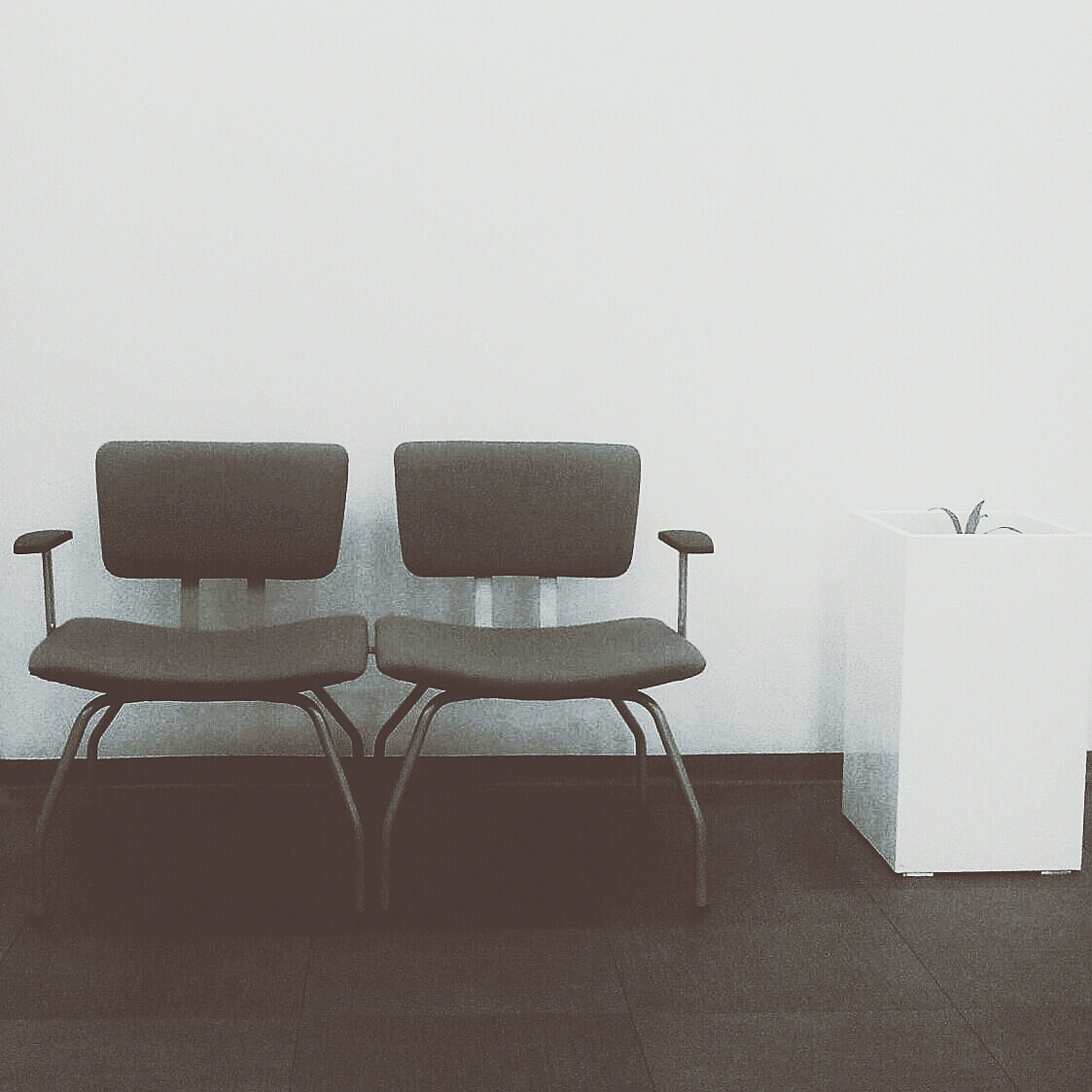 two empty chairs against the wall
