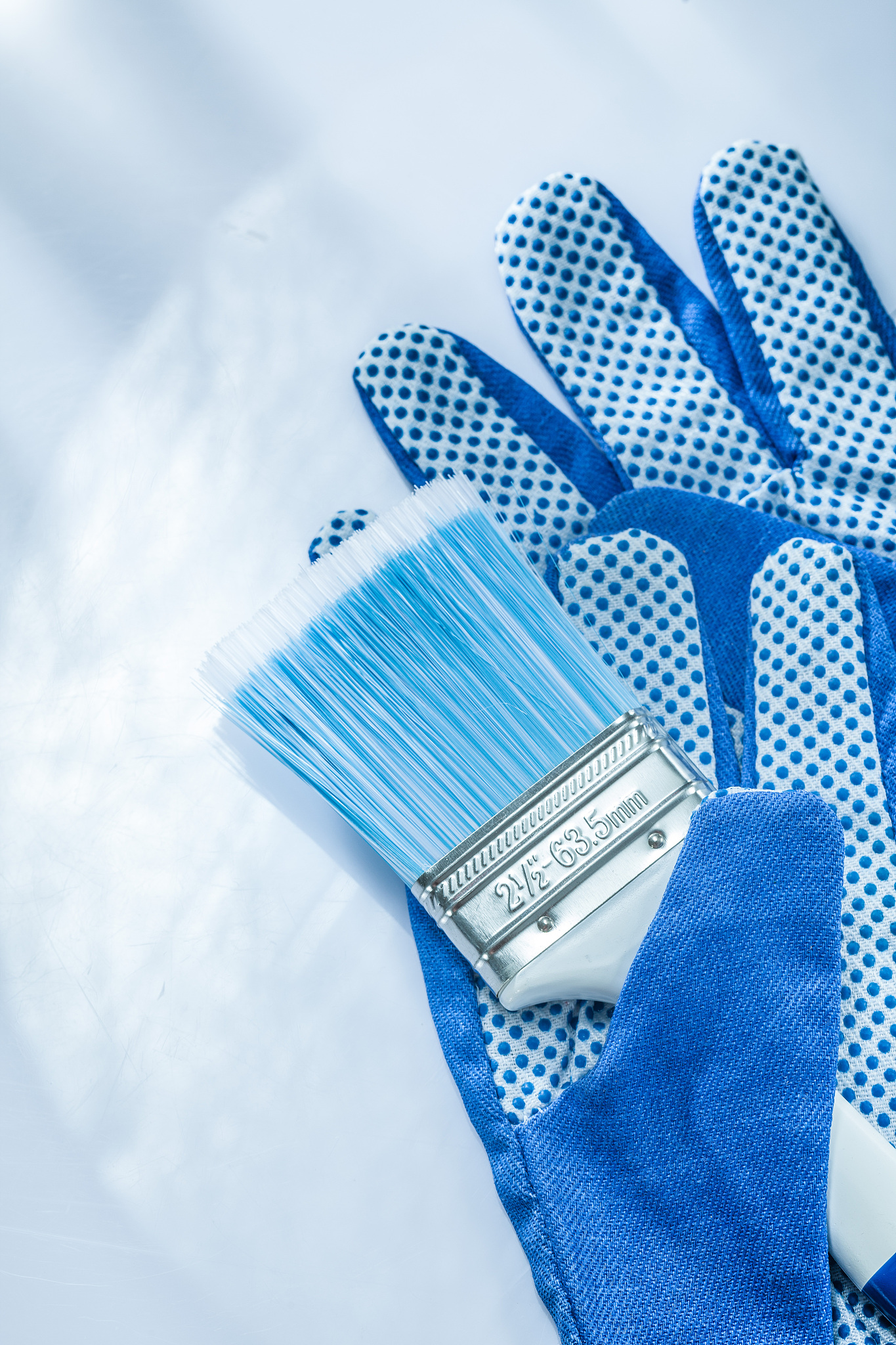 protective gloves paint brush on white background vertical image