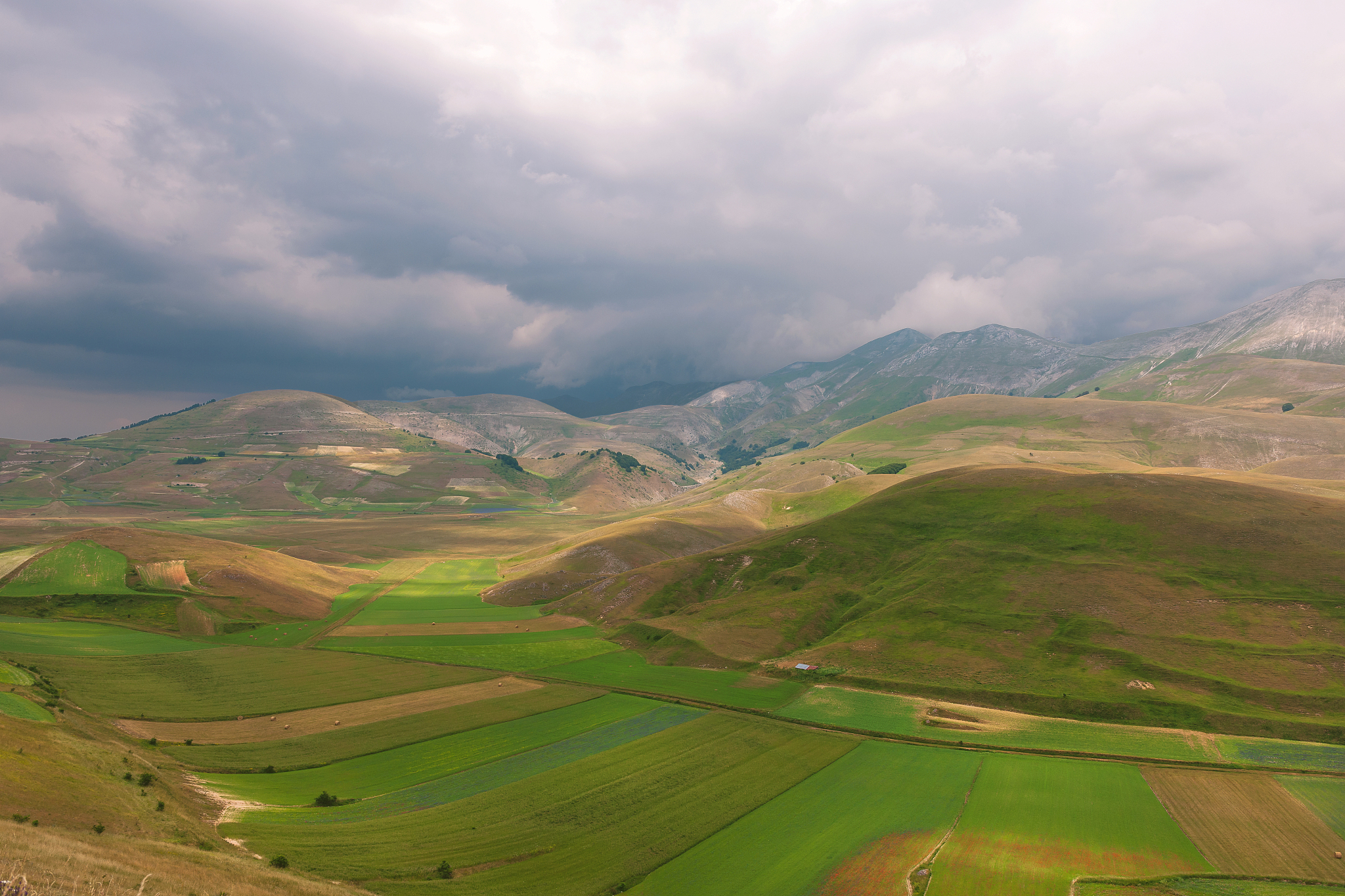 castelluccio di norcia (italy), village on a green hill