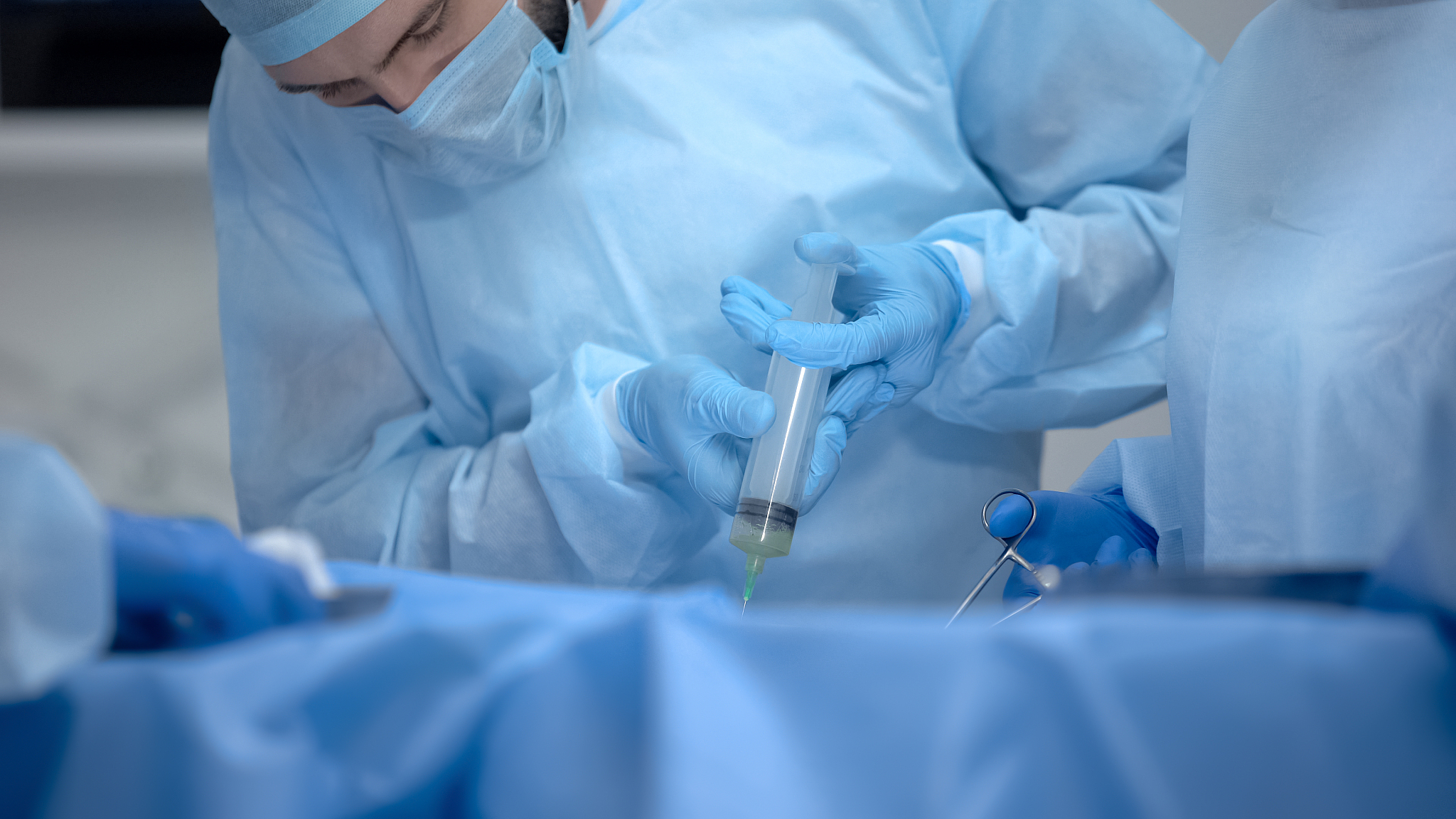 professional anesthesiologist making injection during hospital o