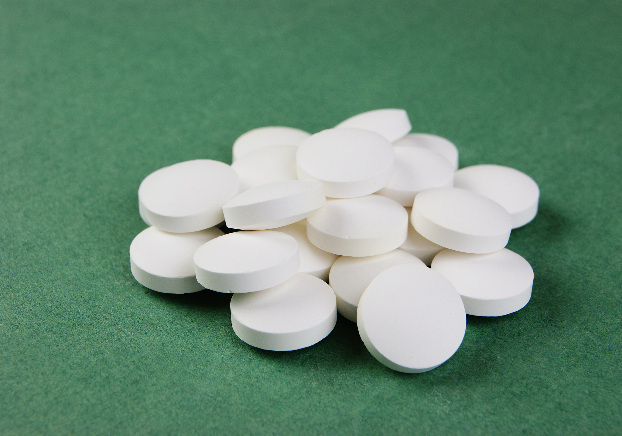 white tablets on a green background
