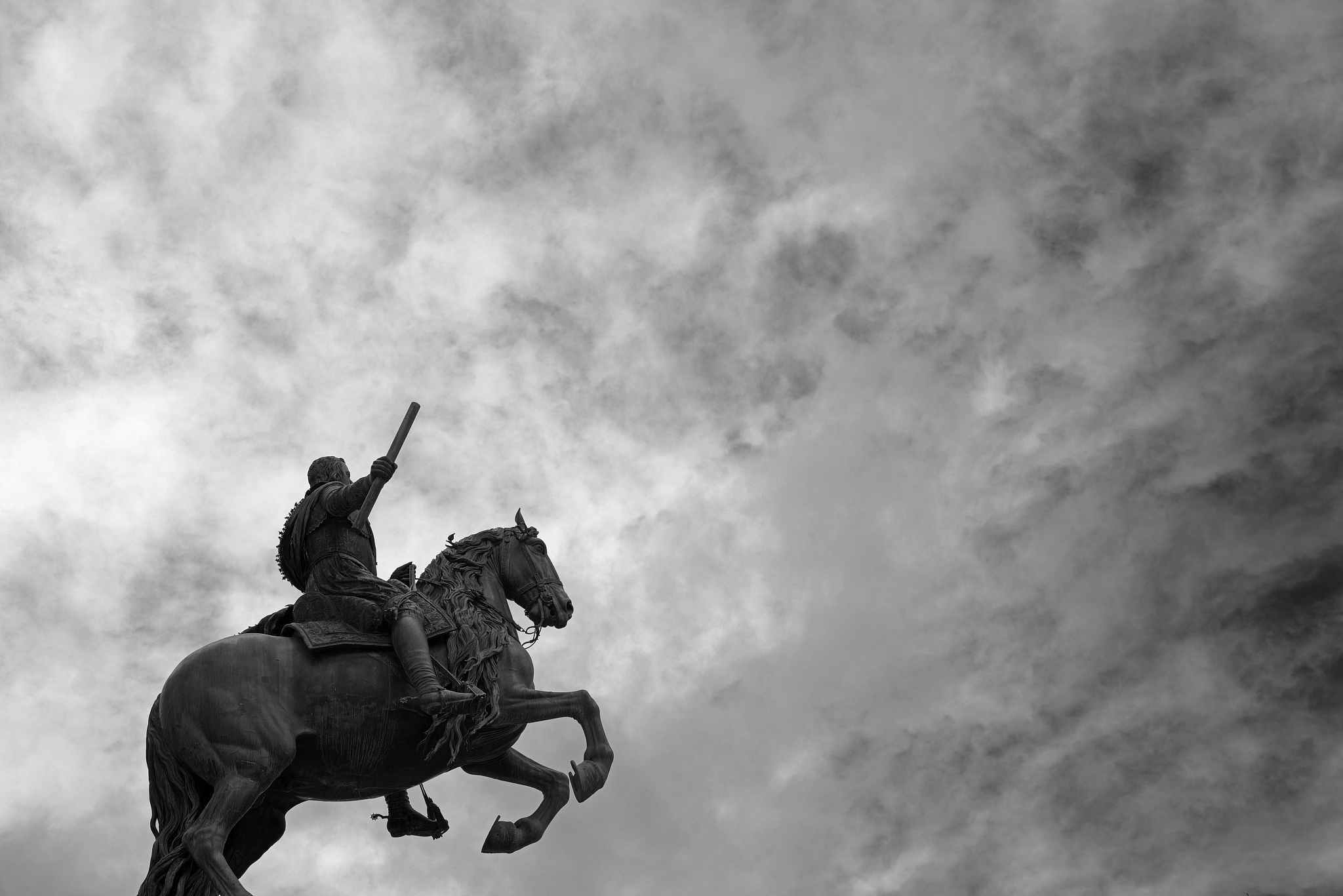 equestrian bronze statue against a cloudy sky