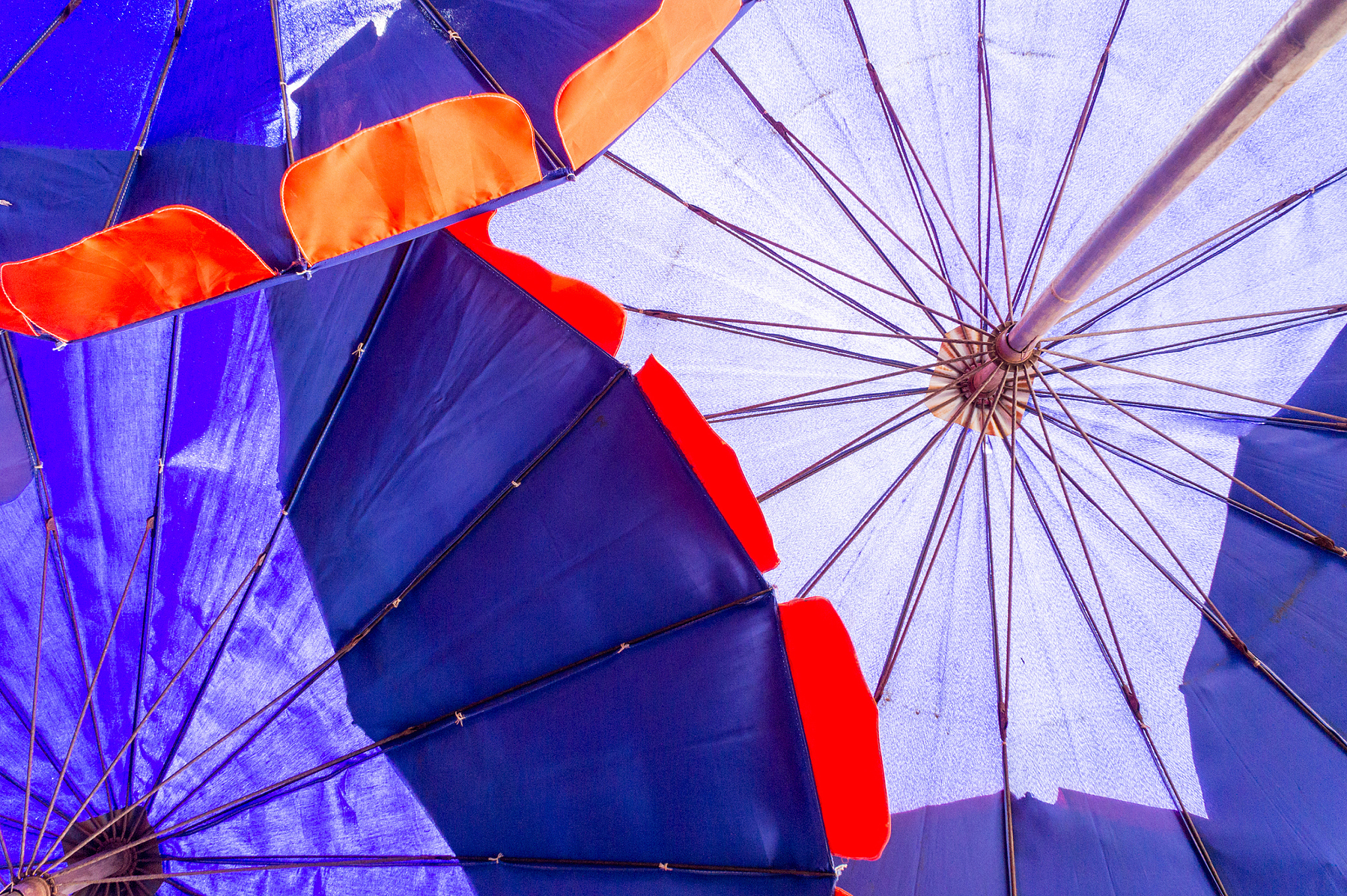 close up under blue umbrella on the beach.