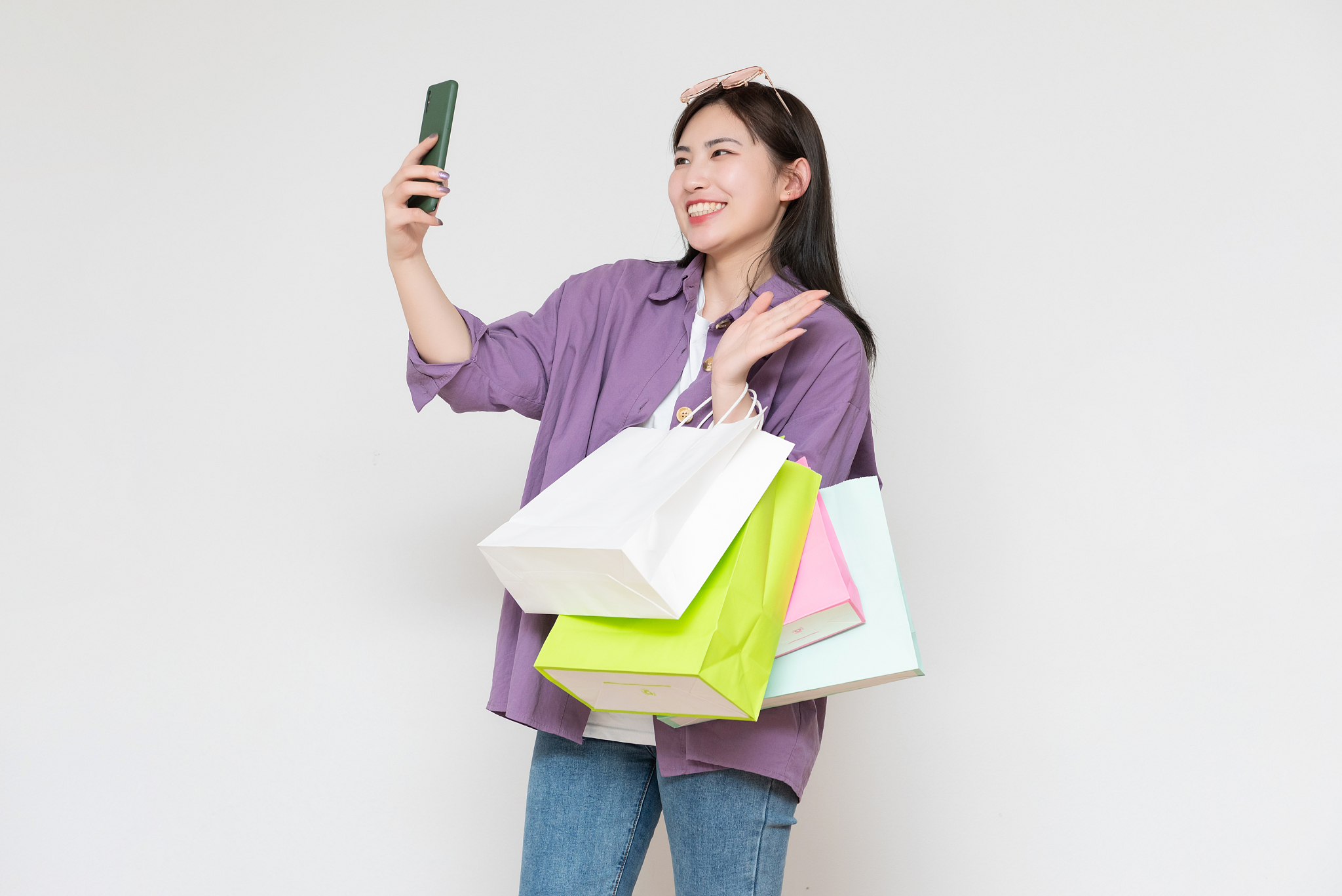 a young asian woman with a shopping bag in her hand
