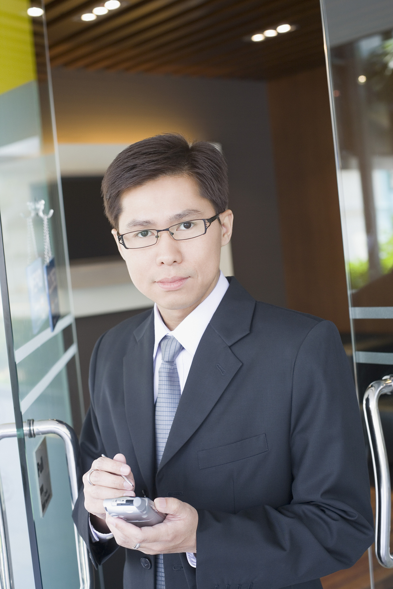 businessman with cell phone in doorway