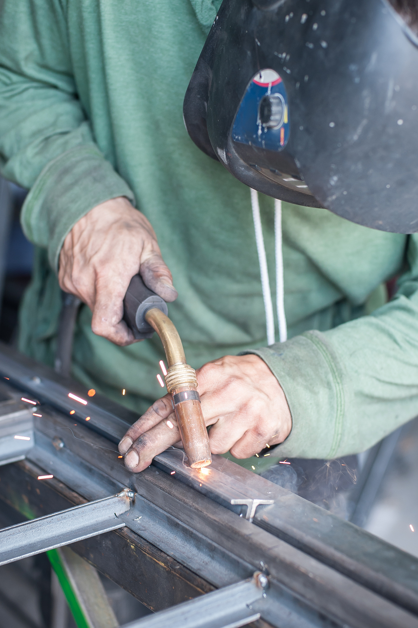 industrial welder working a welding metal with protective mask